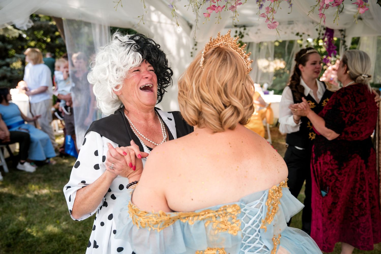 Wedding guests share joyful embraces and laughter at a wedding.