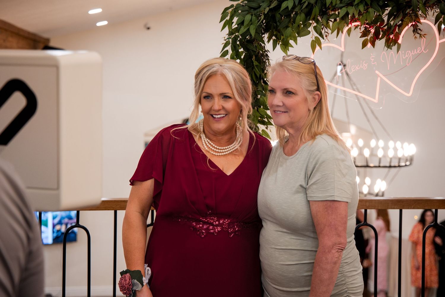 Two people laughing and embracing while dancing together at an indoor event.