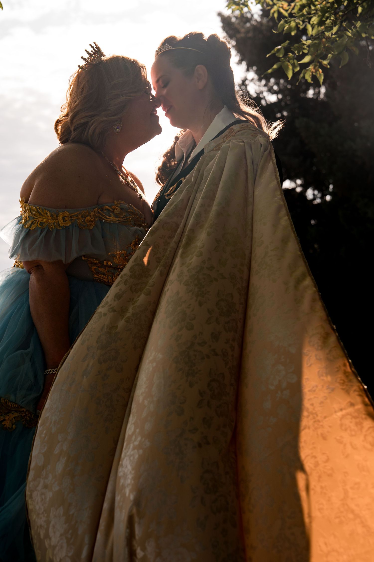 Couple in vintage-style dress embracing during golden hour sunset captured in multiple sequential romantic frames.