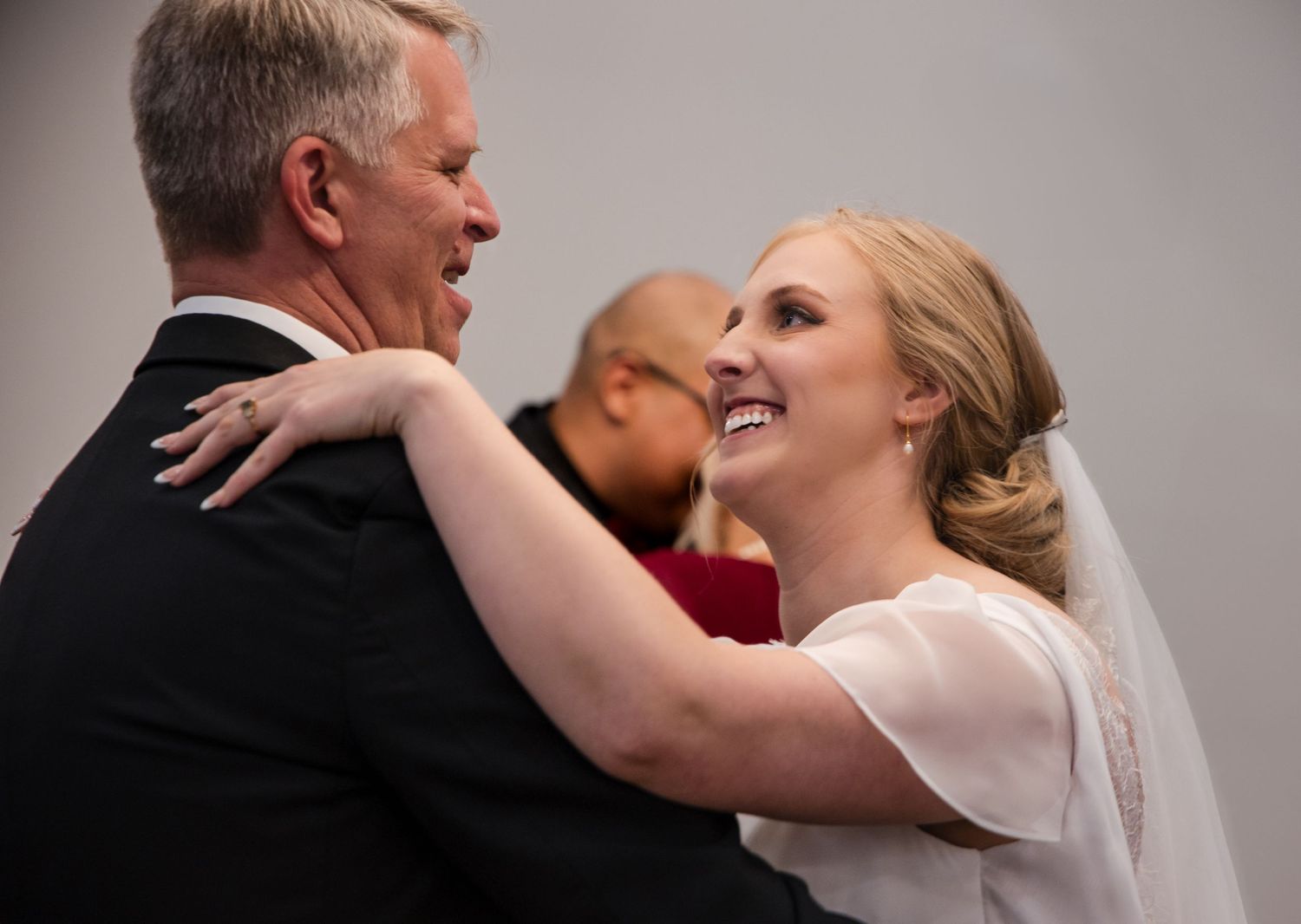 A tender dance moment captured between two people at a wedding celebration.
