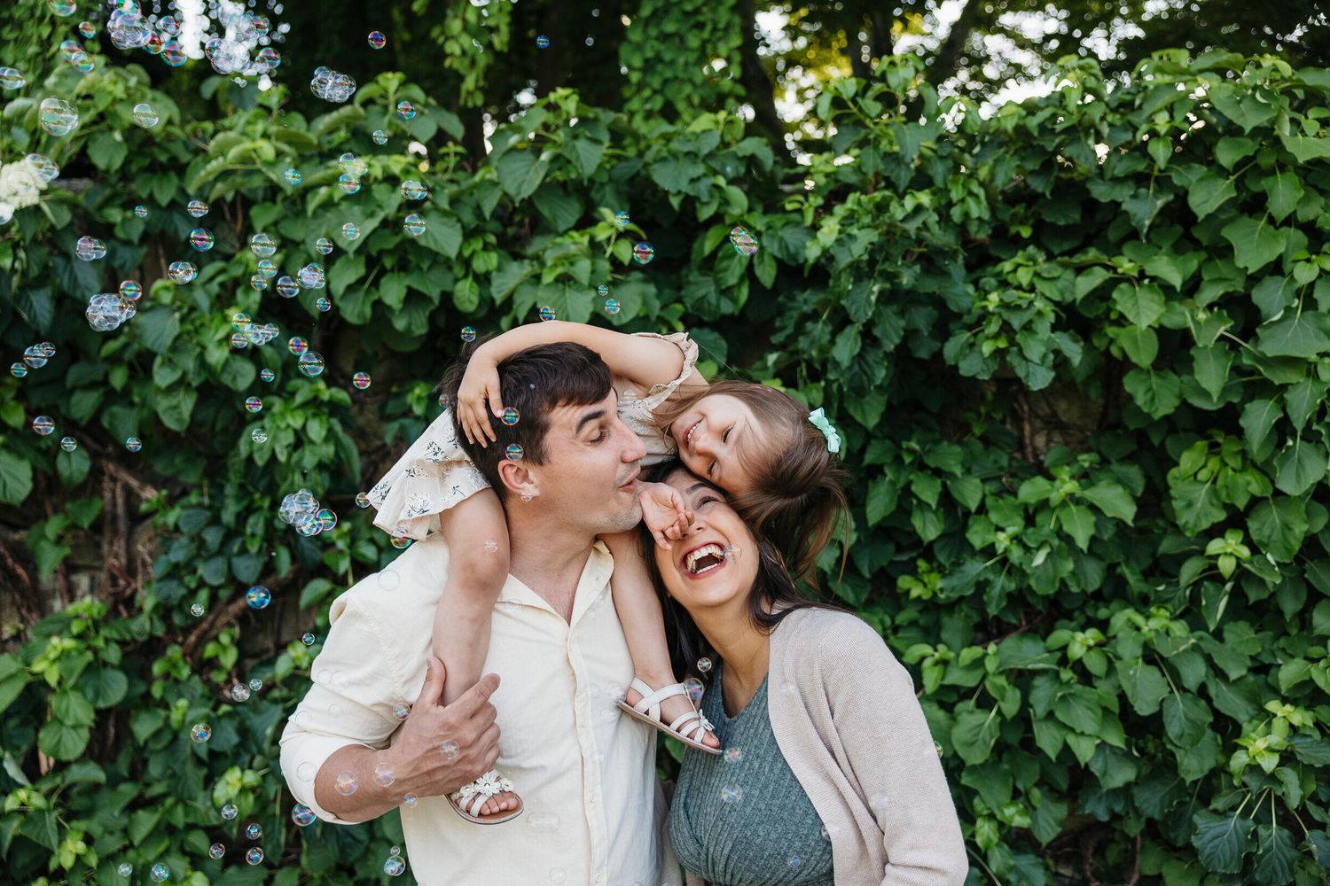 Joyful candid moments shared between couple in lush green garden setting.