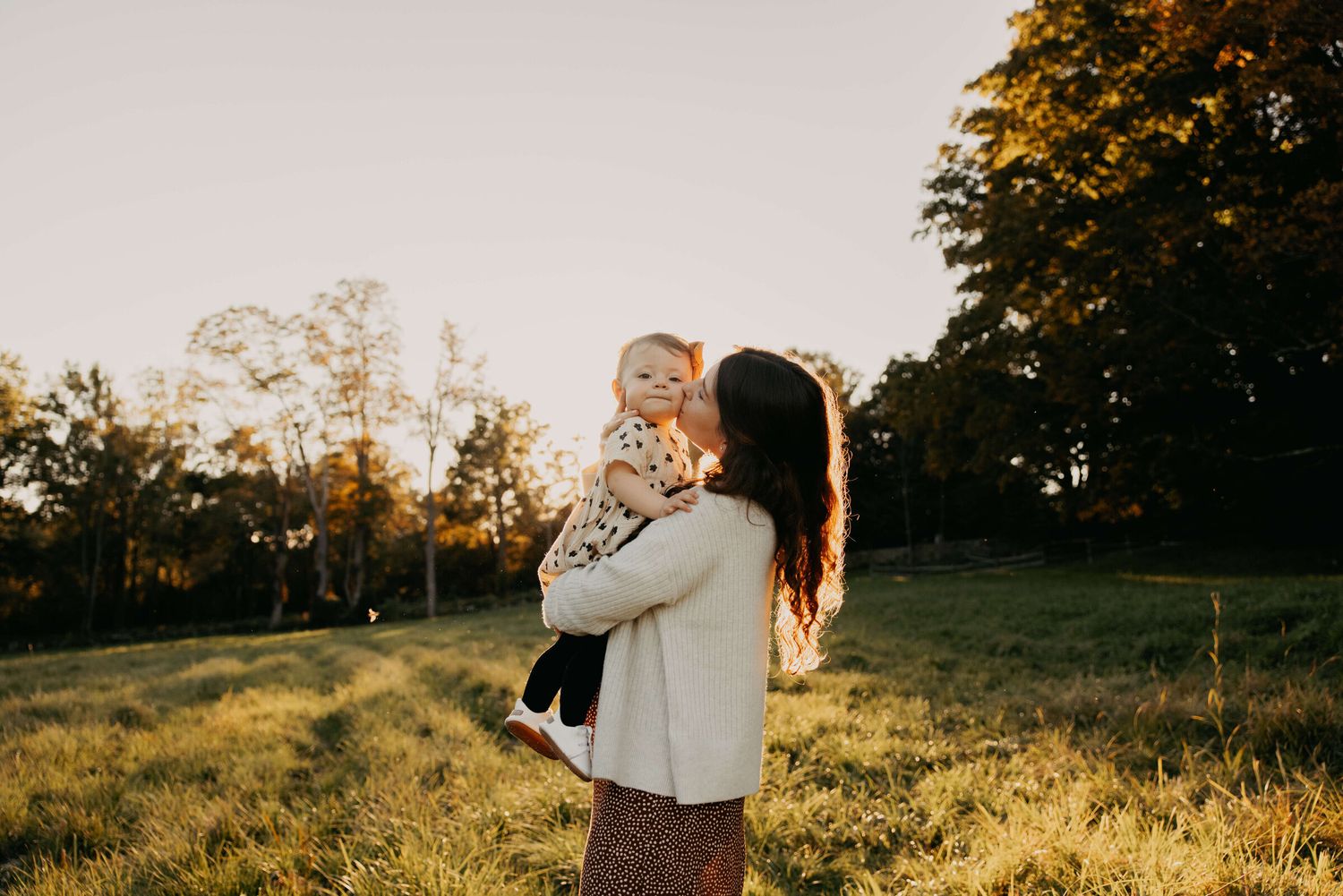 Serene outdoor setting at sunset with soft golden light filtering through trees.