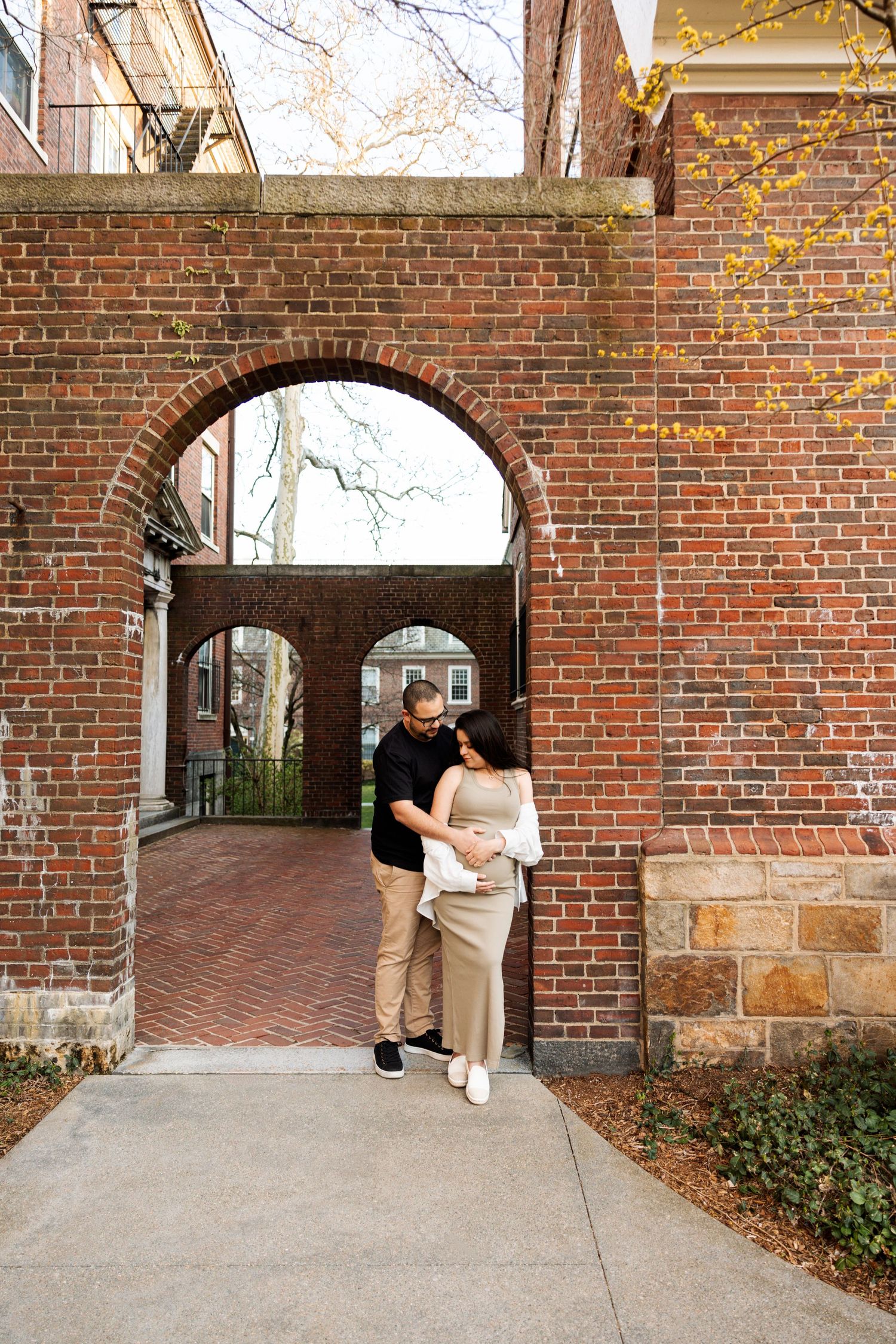 A sequence of photos showing a couple on a brick archway corridor during a lifestyle photoshoot.