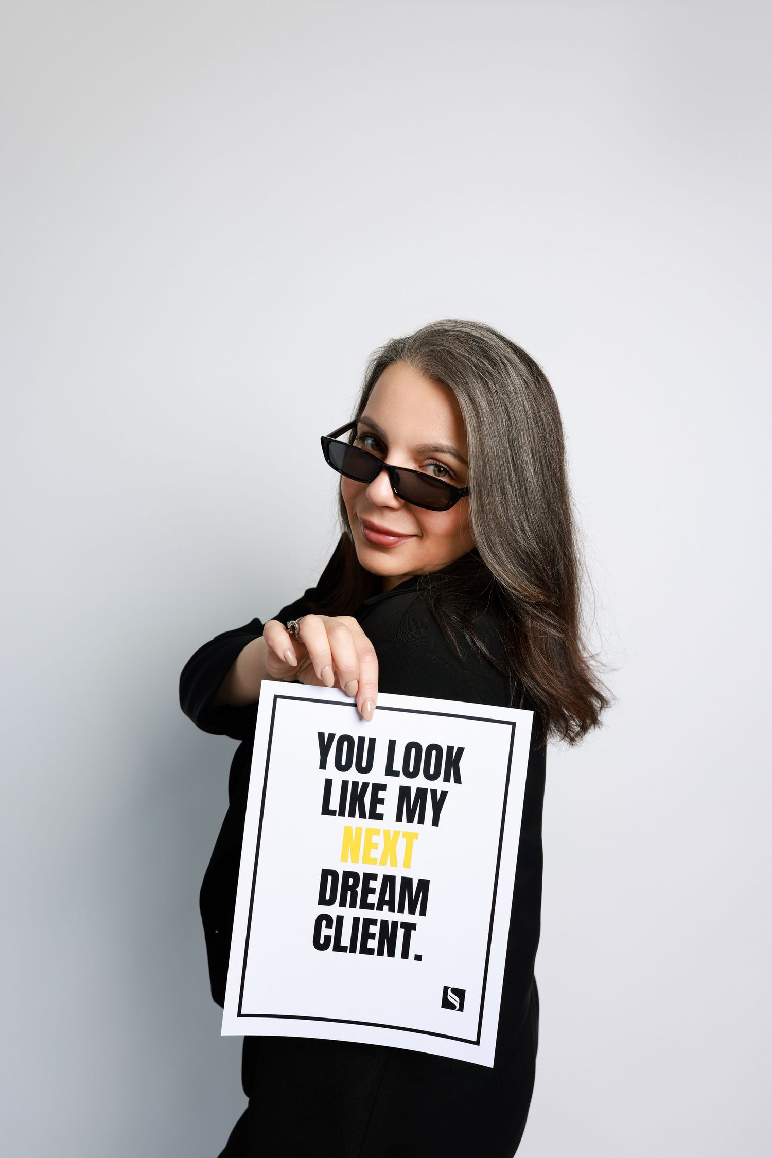 A series of three portrait photos shows a person in black holding signs with progressive text about looking like their client.