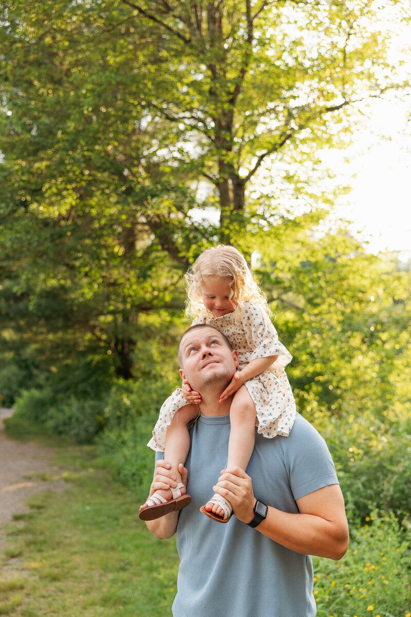 Playful outdoor photo session with ice cream treats in sunny park setting.