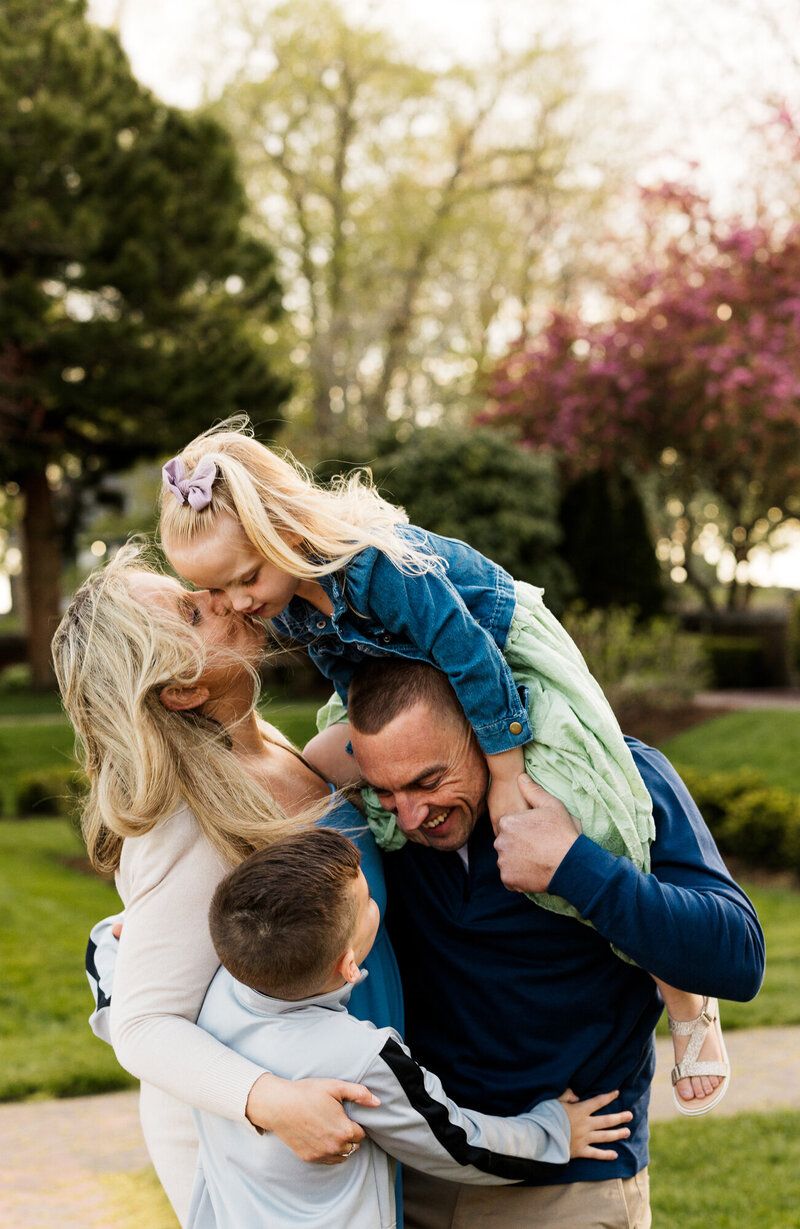 Energetic family photos showing playful moments in a spring garden setting.