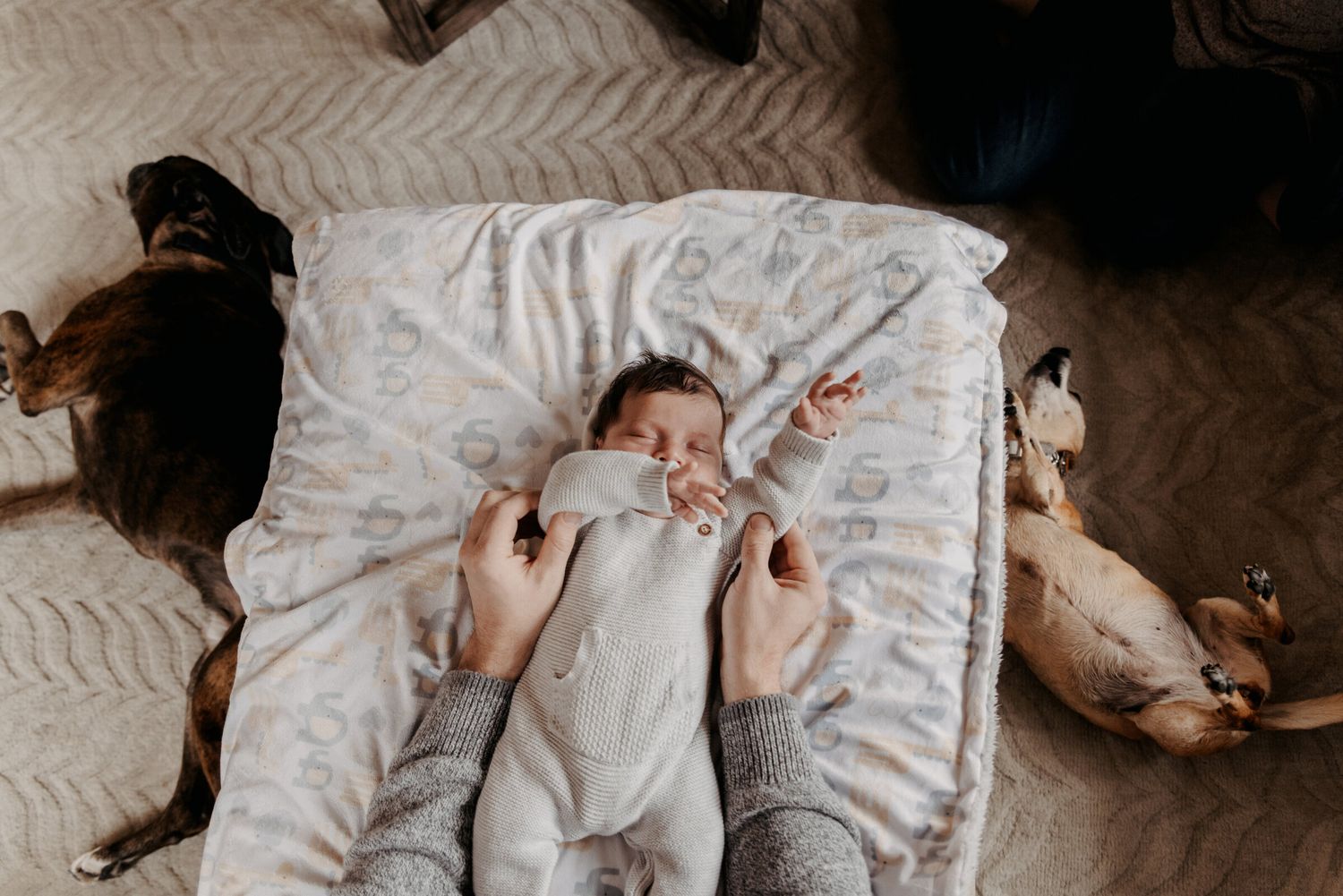 Overhead view of a peaceful sleeping infant on white textured bedding.