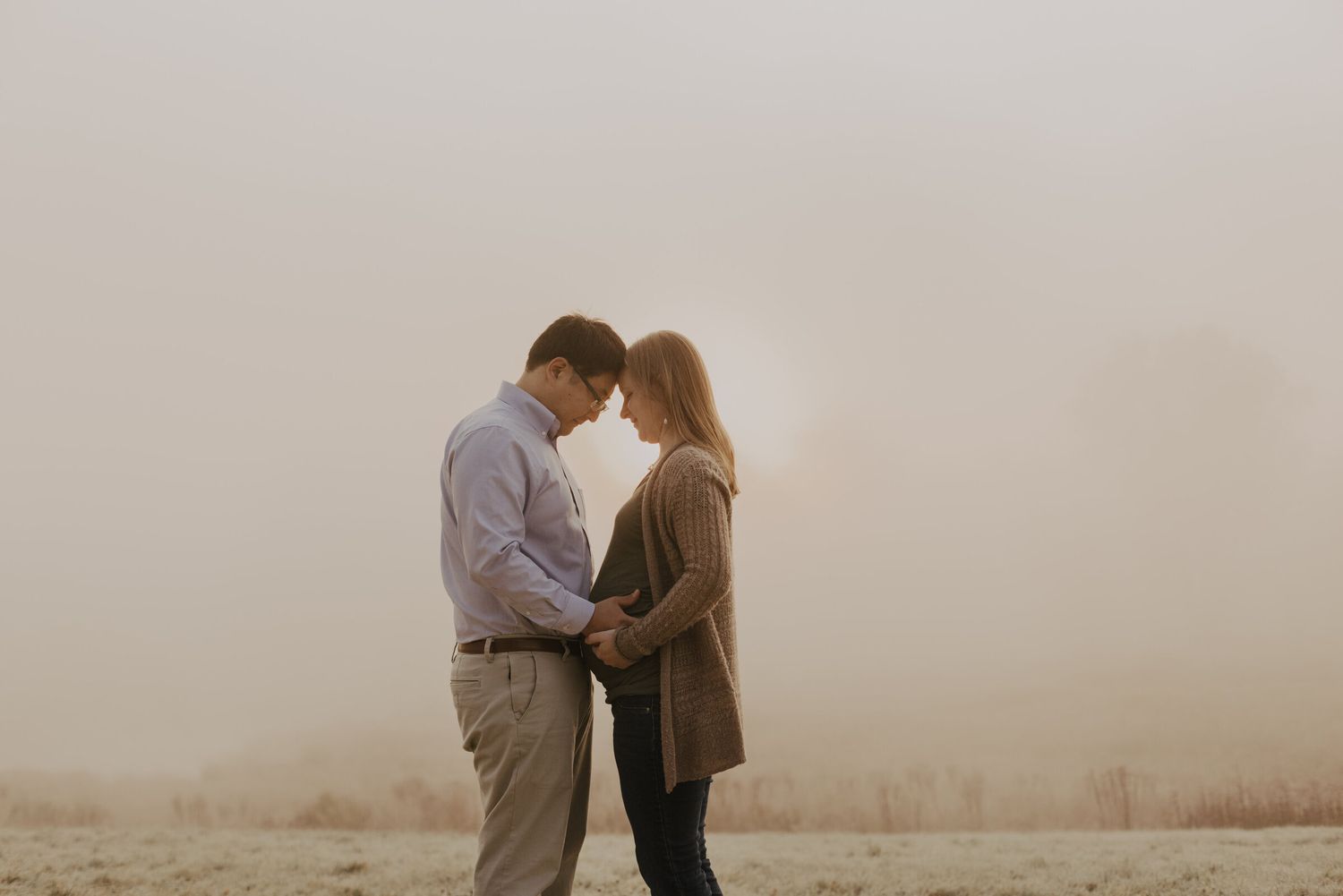 Intimate beachside engagement photos captured in soft, misty light.