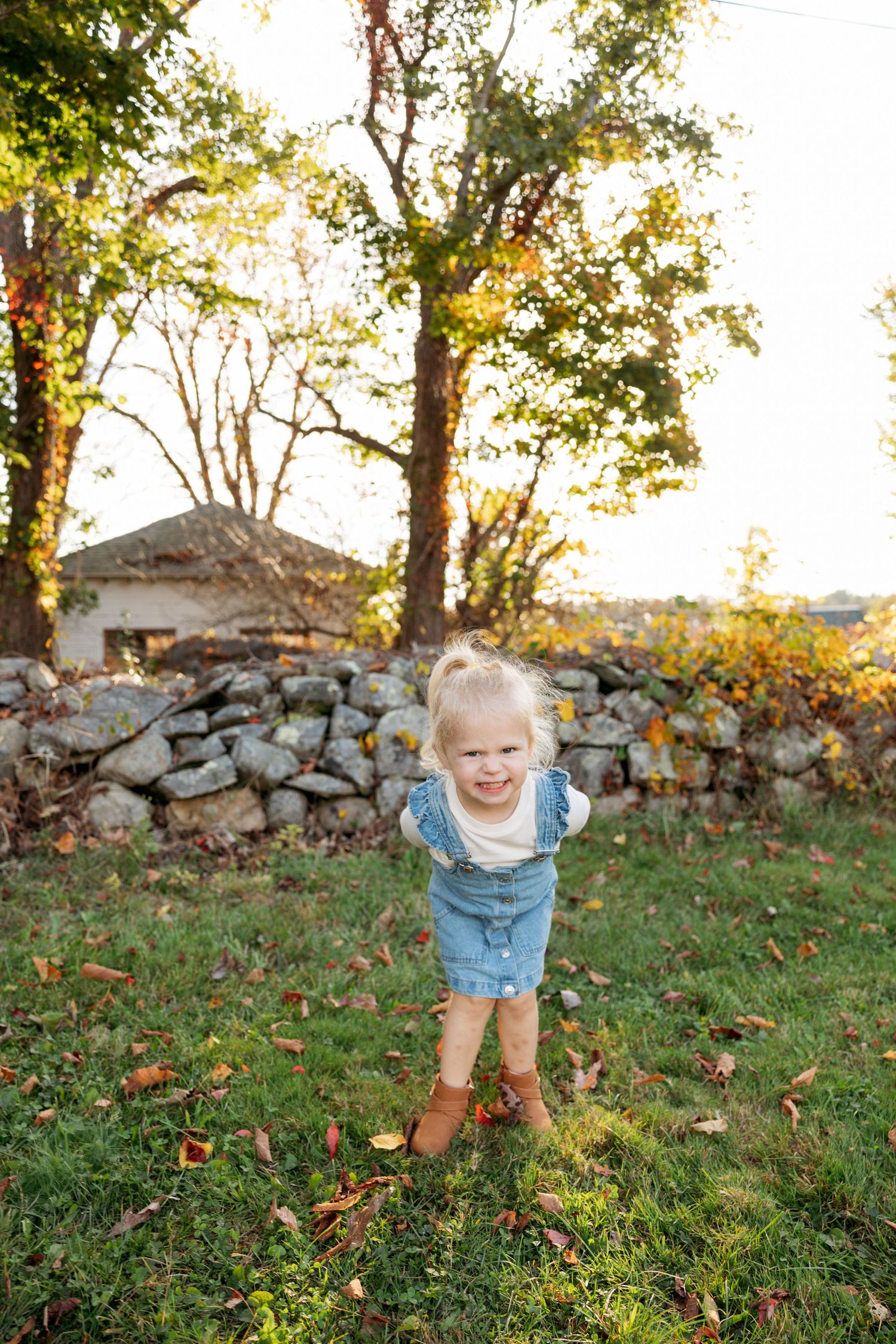 A playful sequence of outdoor photos set against autumn foliage and stone wall background.