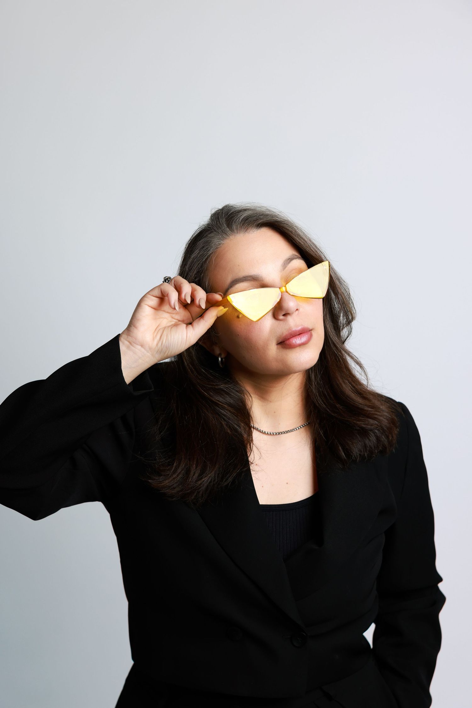 Fashion portraits with yellow butterfly accessories against white studio background.