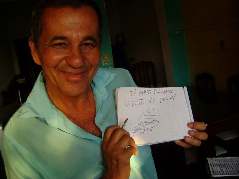 Series of images showing someone holding up handwritten messages indoors.