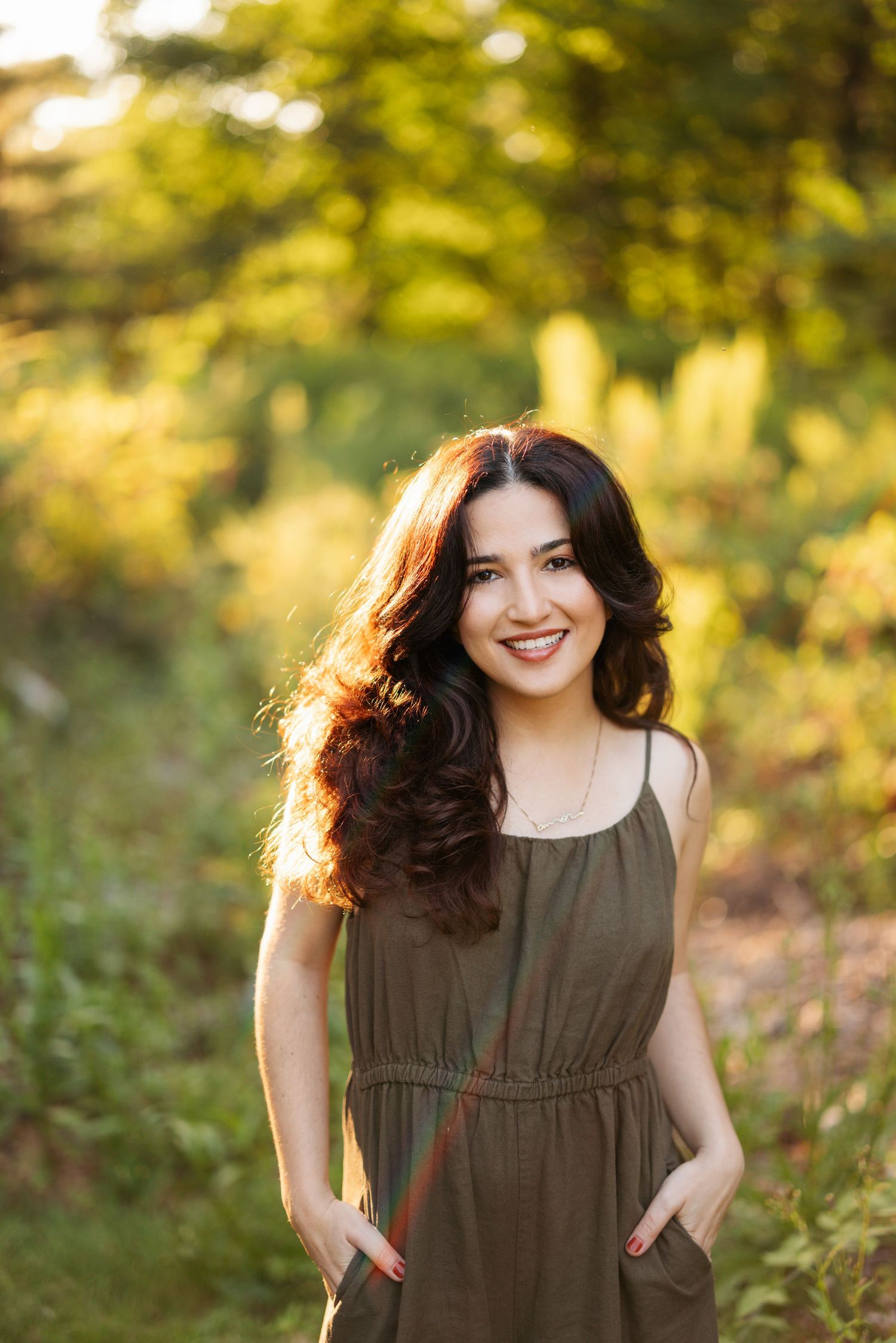 Sunlit outdoor portrait session in a lush garden setting with warm golden lighting.
