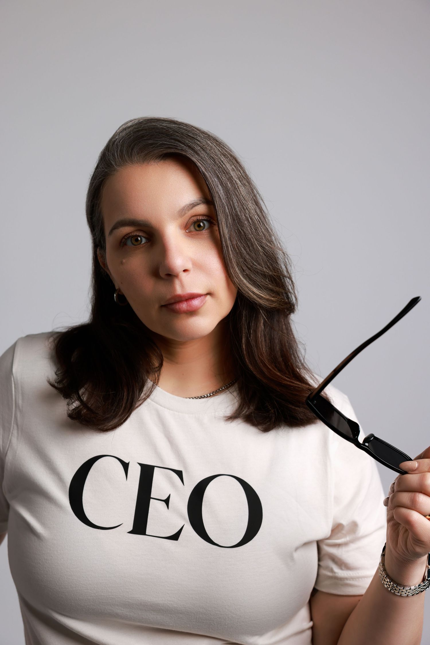 A progression of four images showing someone wearing a white t-shirt with partial text that spells out CEO.
