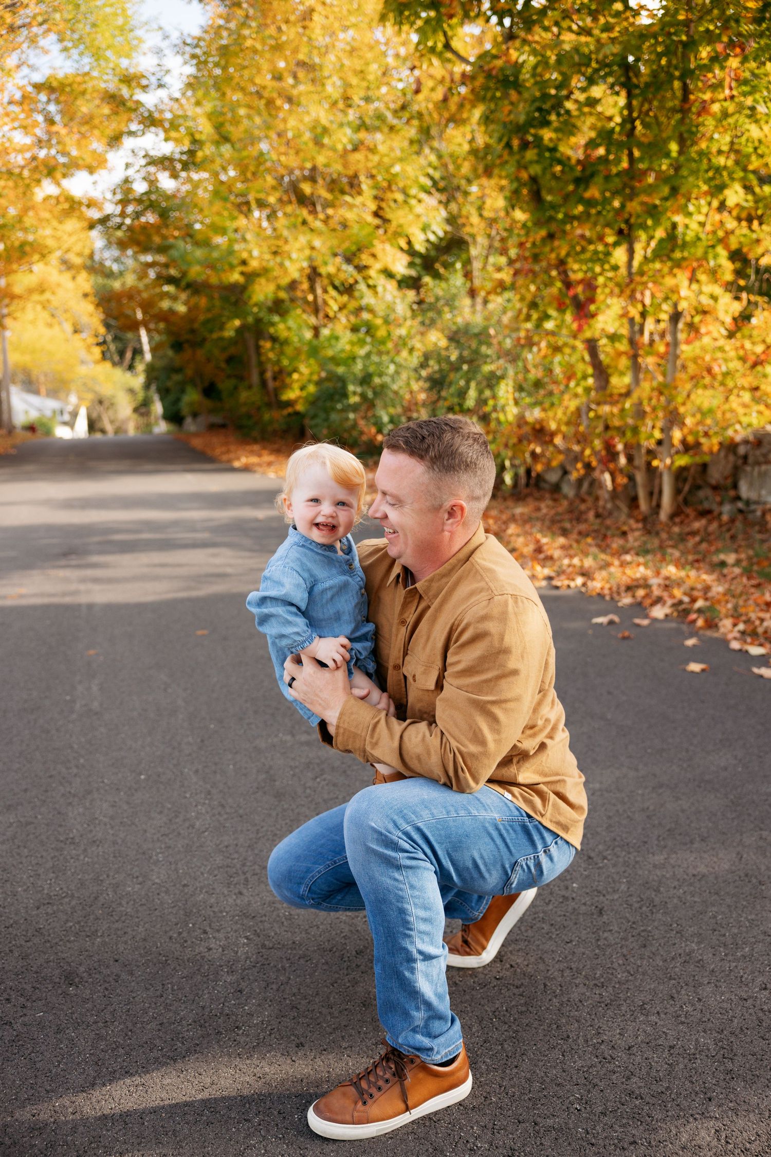A series of candid autumn photos outdoors showing playful interaction in a park setting with fall foliage in the background.