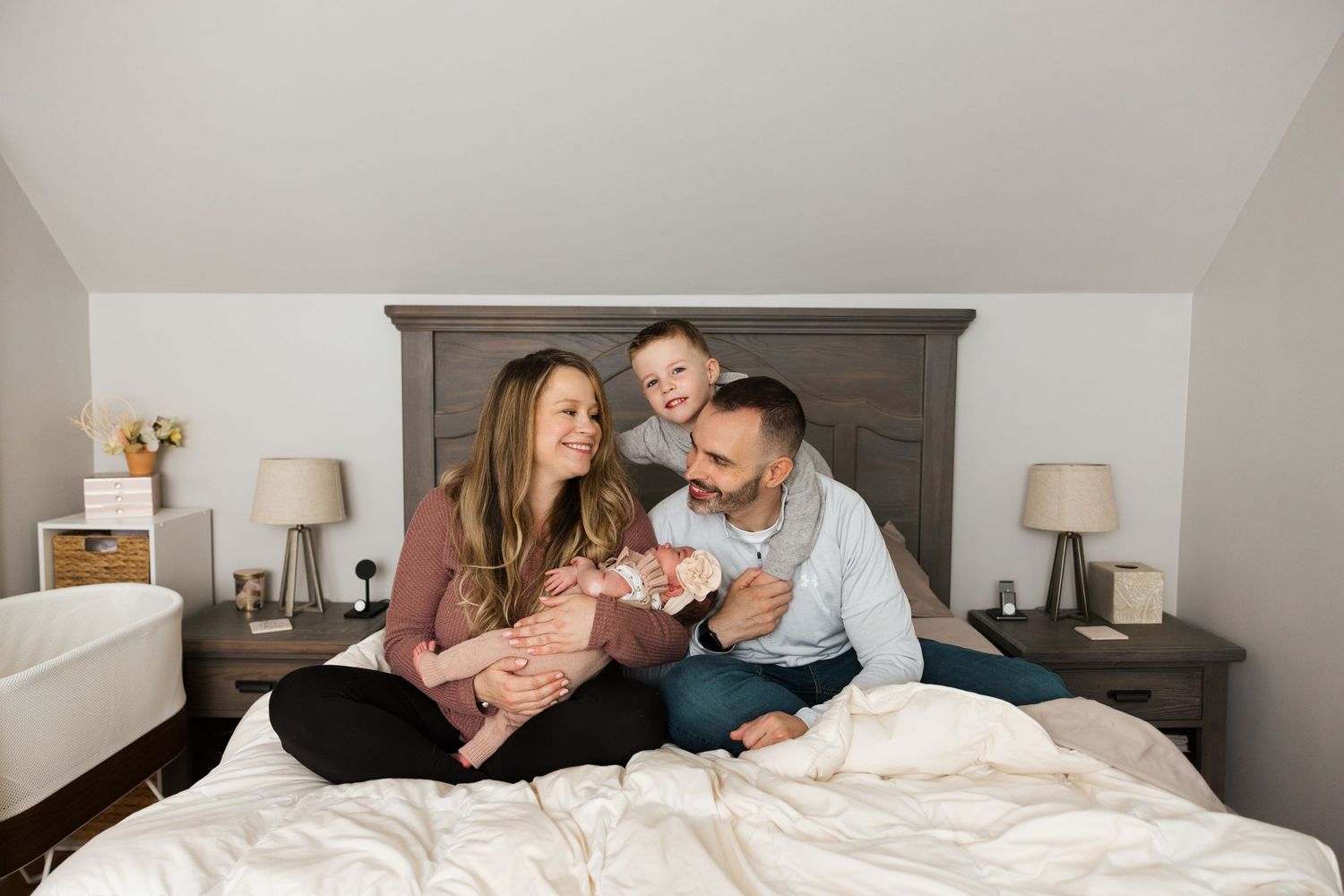 Four connected photos show a couple sharing intimate moments together on a bed with light colored bedding.