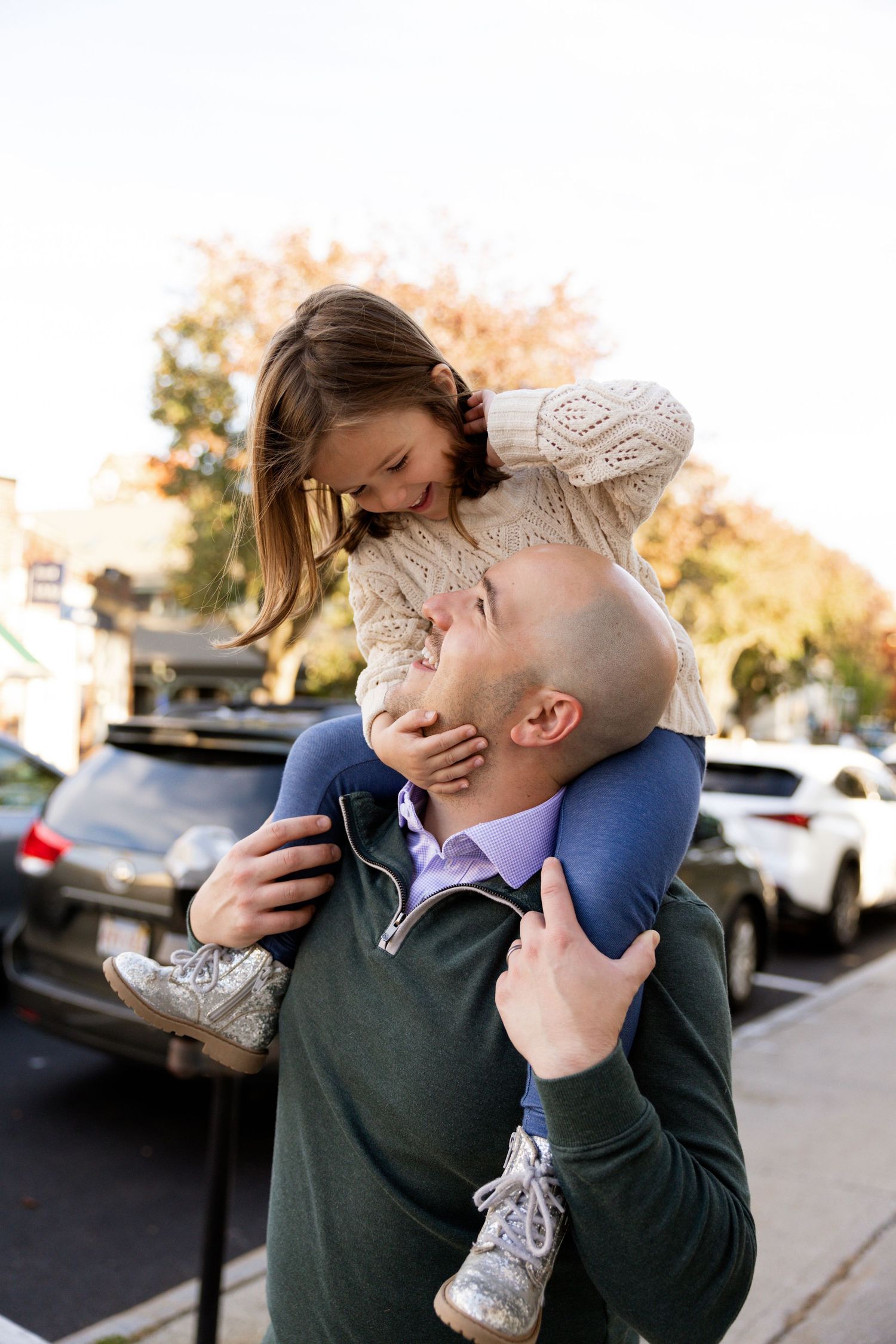 Joyful family interaction outdoors showing affectionate embraces and laughter.