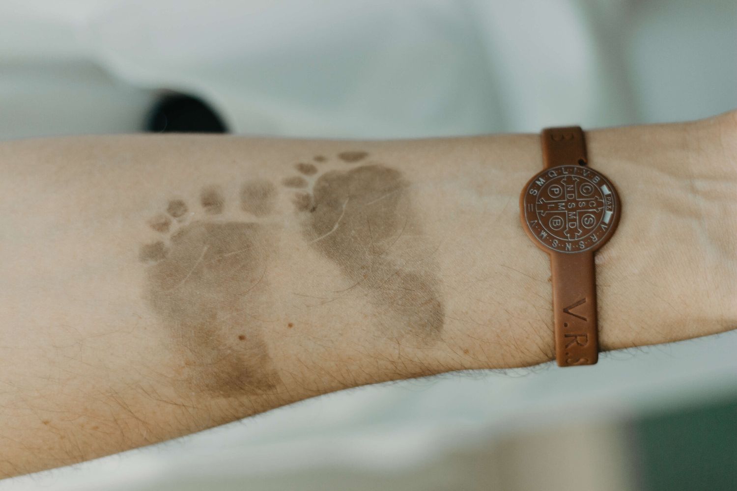 Close-up of dark footprints or pawprints visible on light colored fabric.