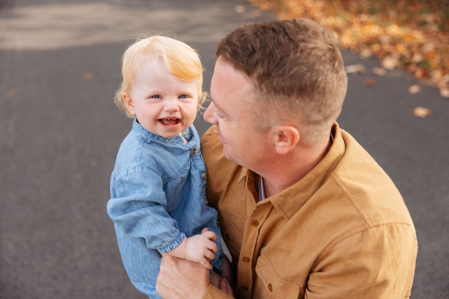 Multiple shots capture tender interactions between adults and a small child against an autumn background.