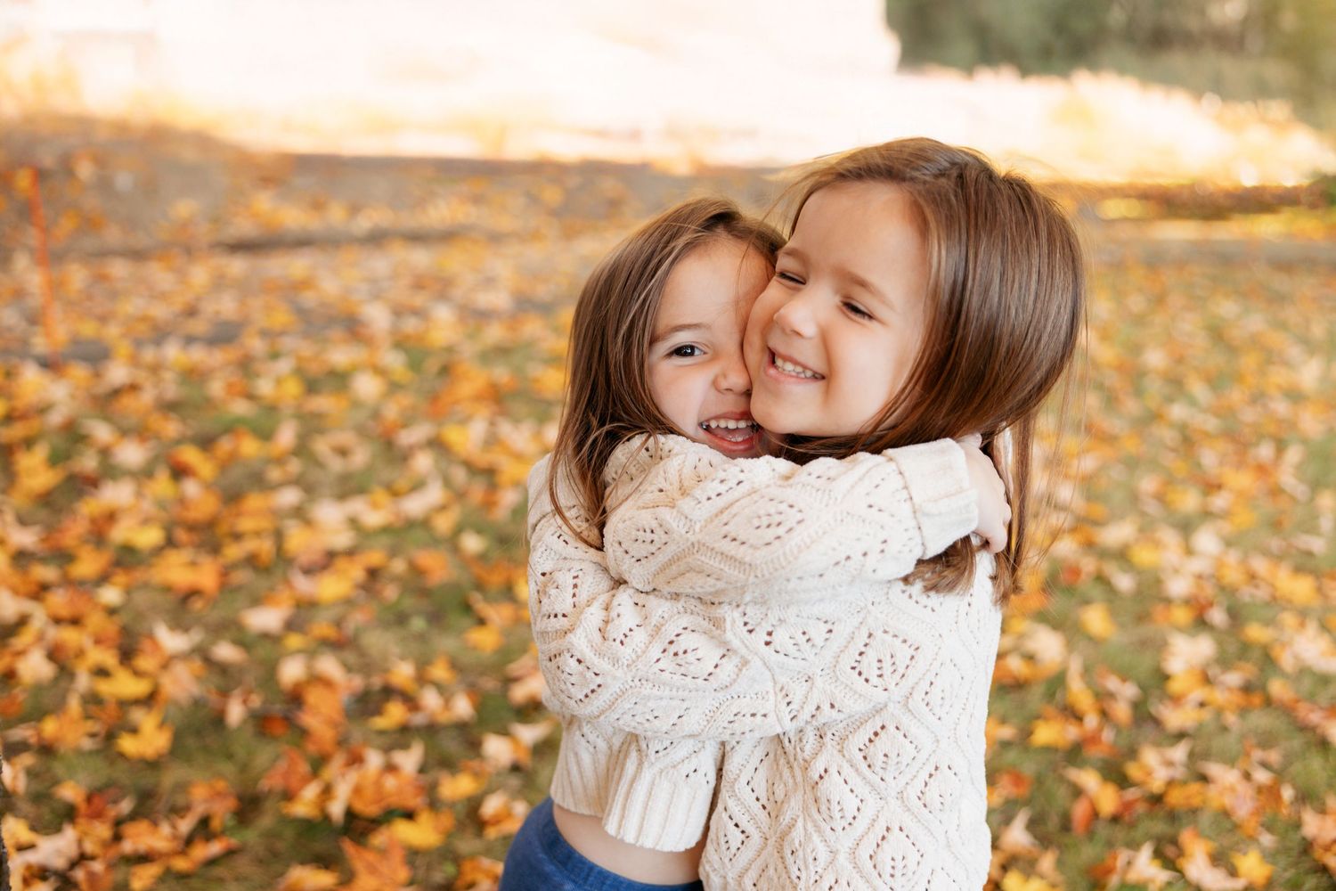 Playful family moments captured in autumn with fallen leaves as a rustic backdrop.