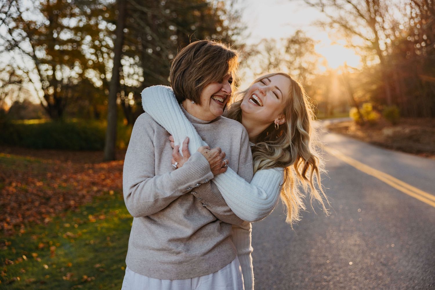 Playful lifestyle photography session in autumn sunlight outdoors.