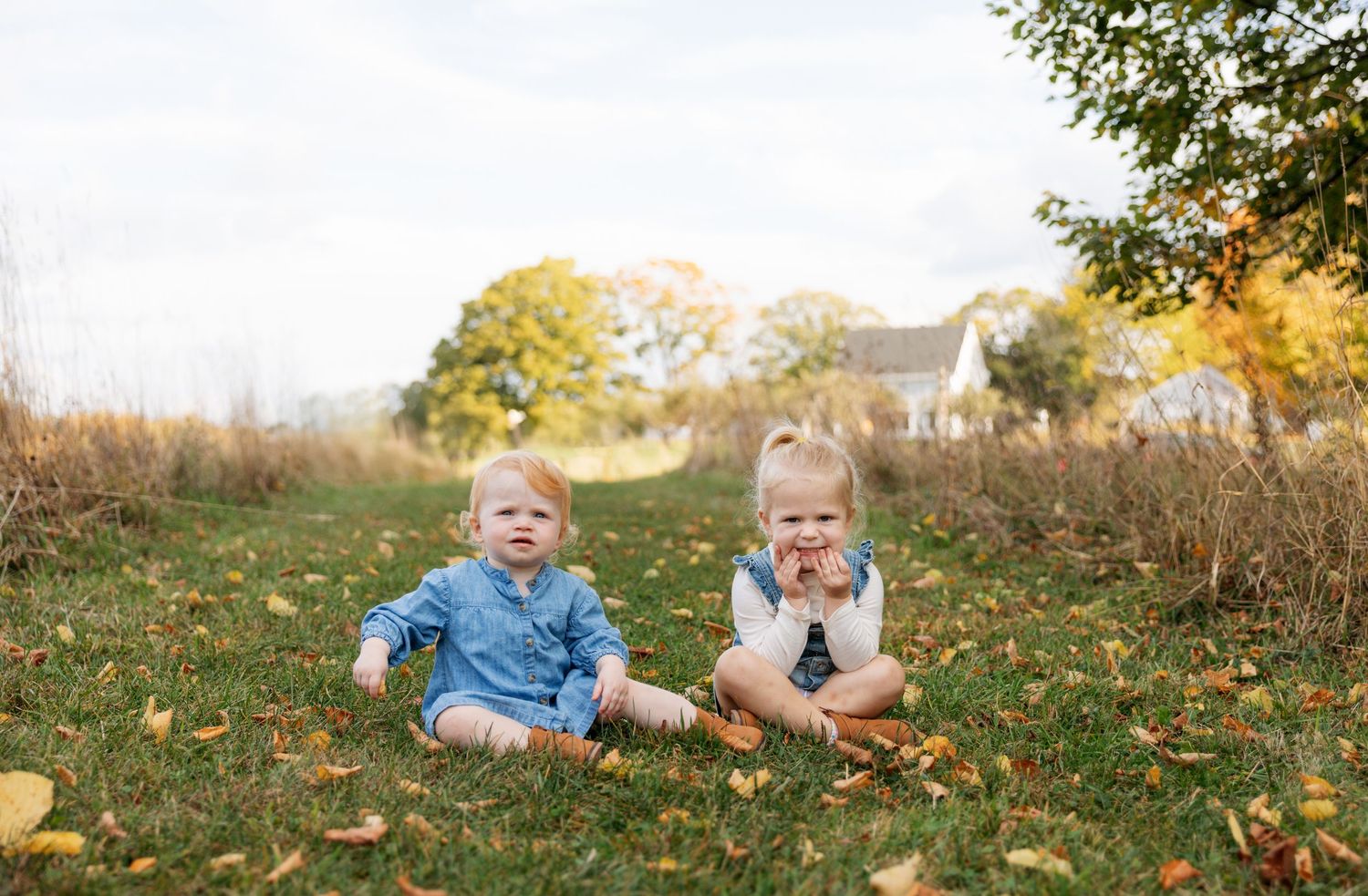 Series of shots show a child playing in grass with autumn leaves scattered across a sunny yard.