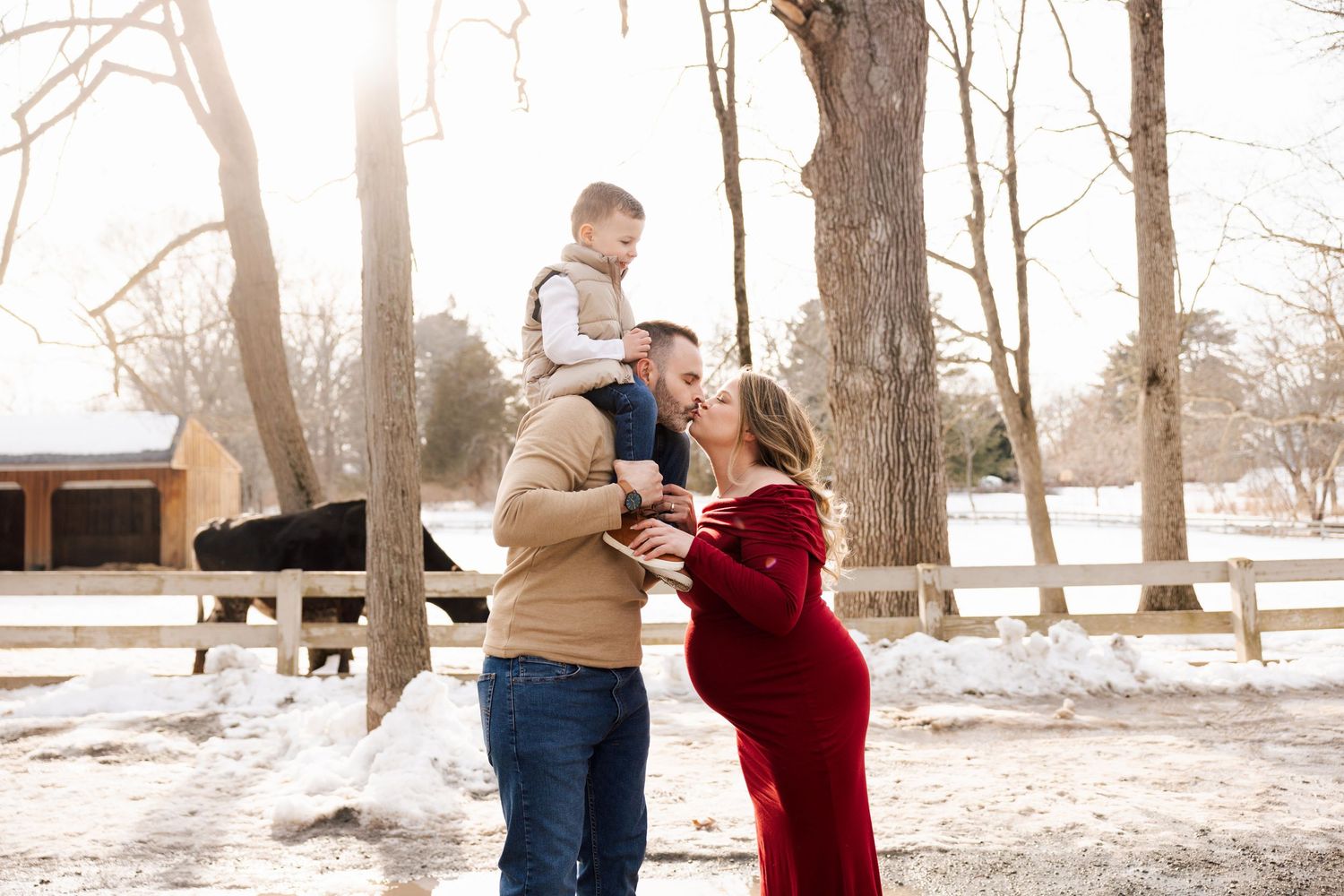 Couple sharing tender moments during winter maternity photoshoot.
