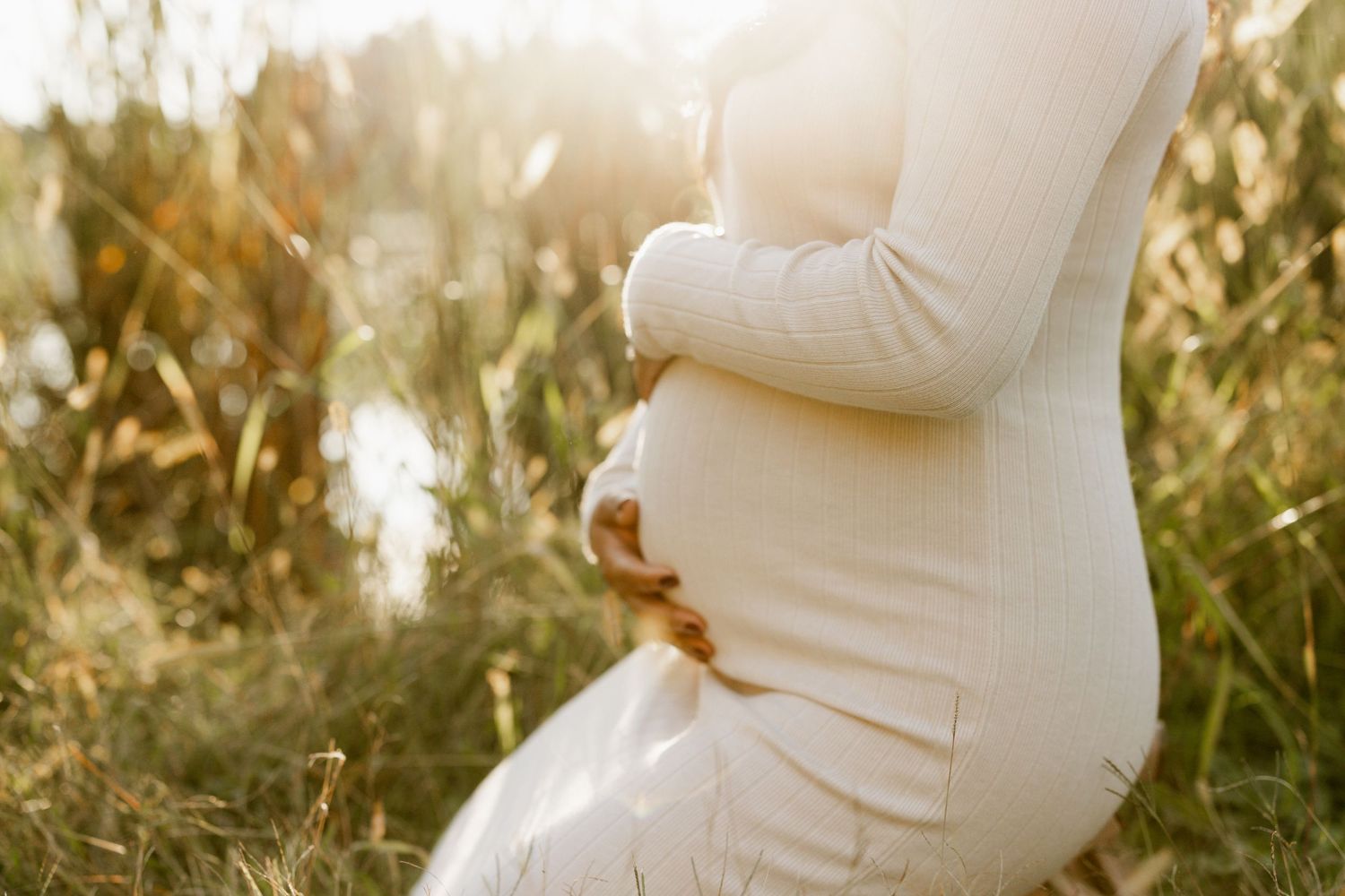 Loving maternity photos showing tender moments in golden evening light.