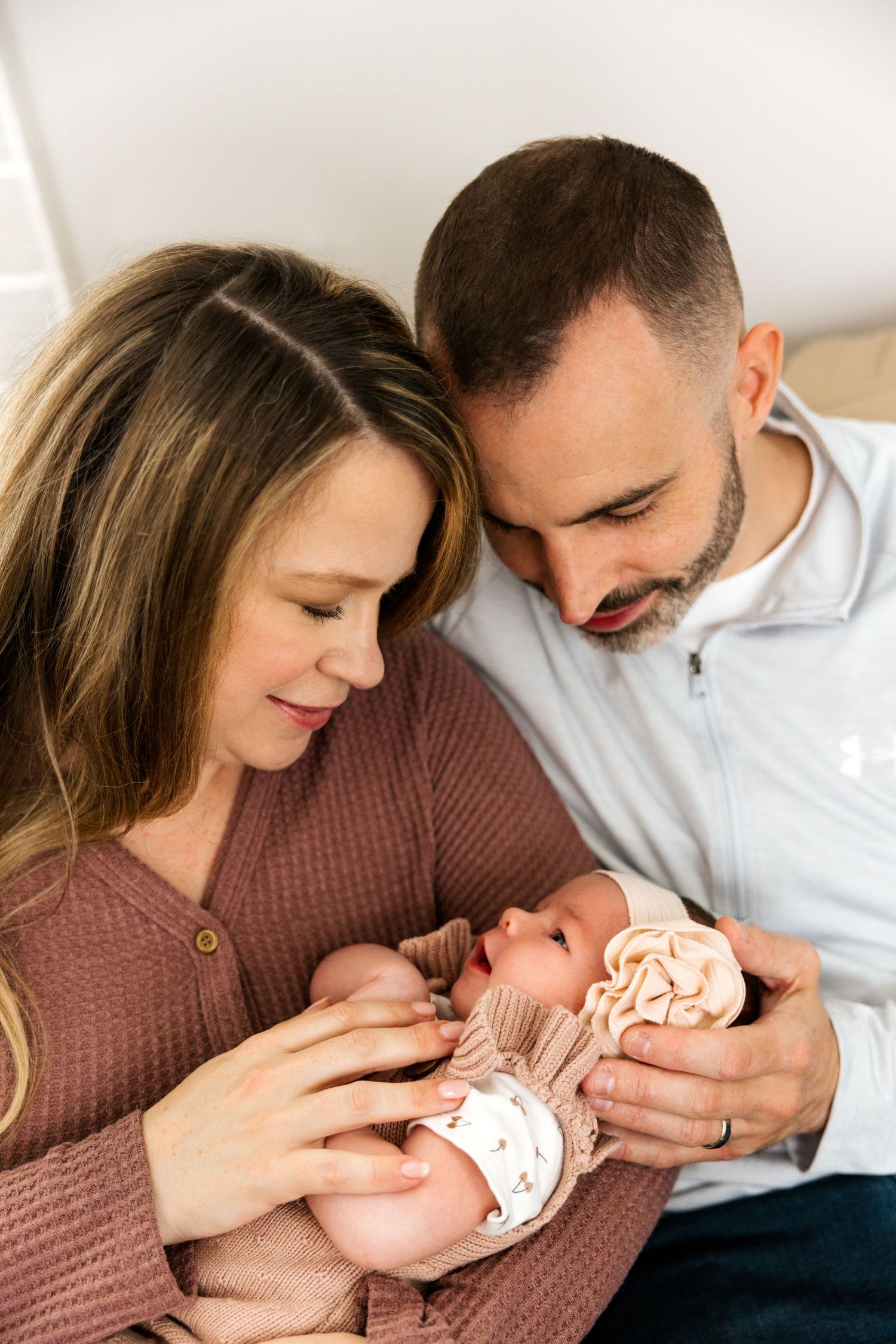 Natural in-home lifestyle newborn photography with soft neutral colors.