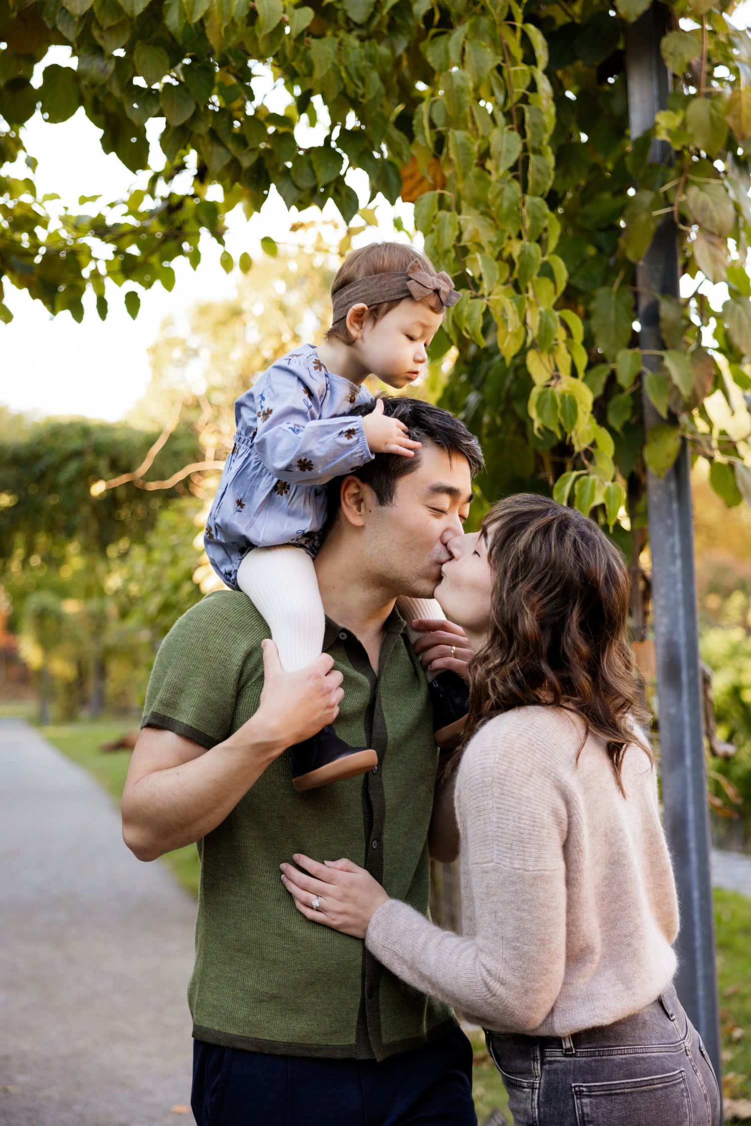 Intimate family moments captured in a park setting during golden hour with autumn foliage.