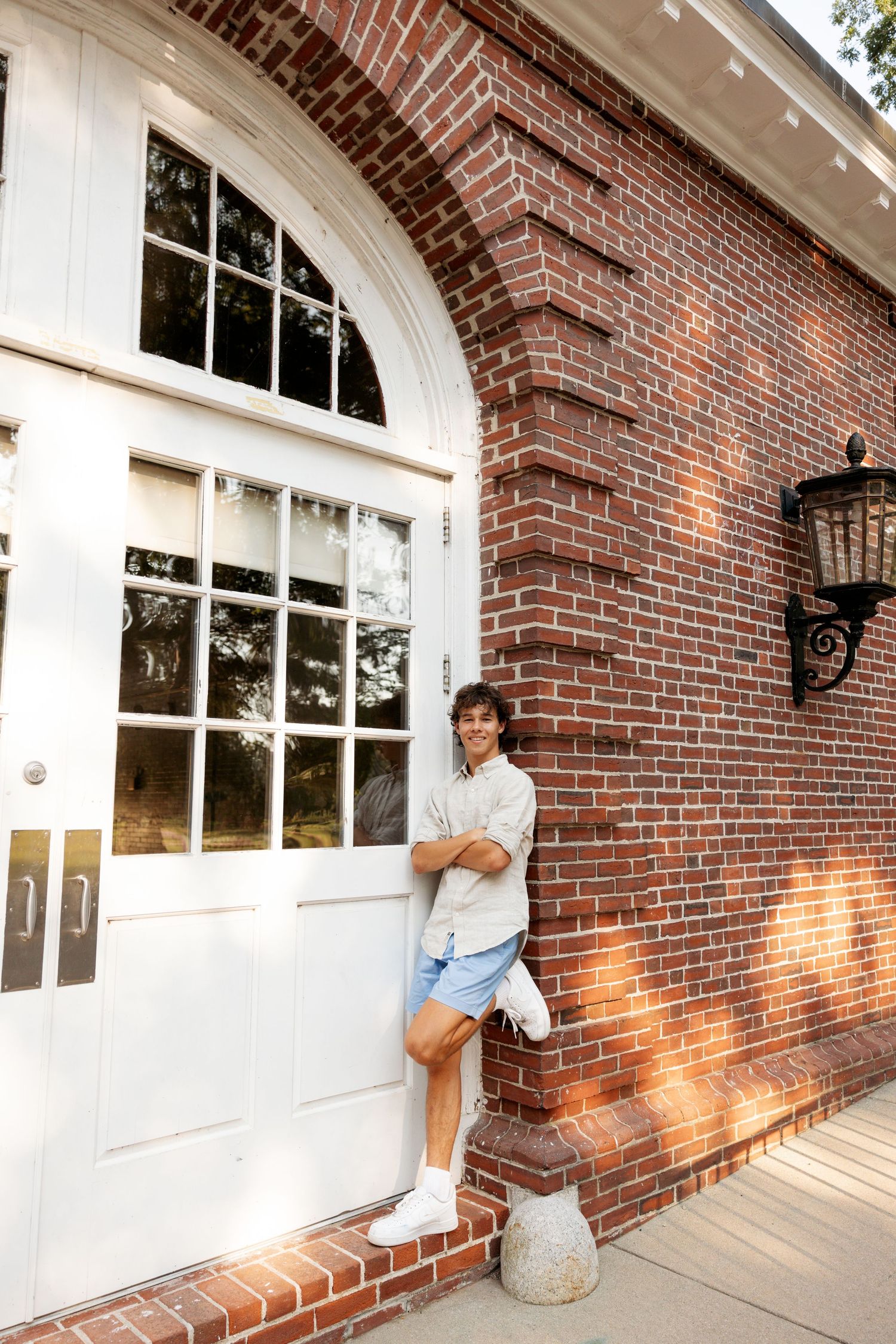Three portrait style photos taken outside a historic brick building with arched windows and white trim.