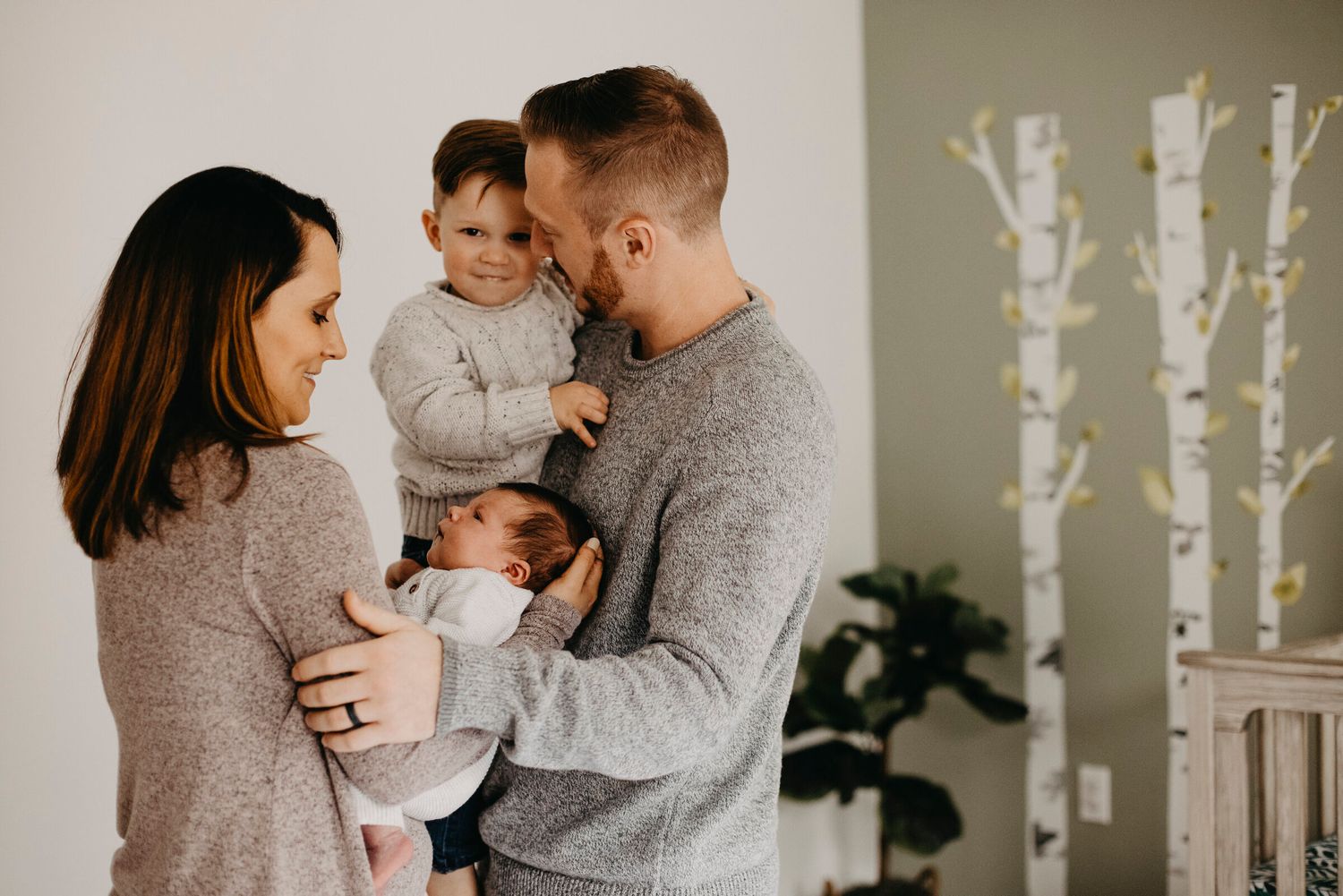 Family of three sharing tender moment together in cozy home setting.