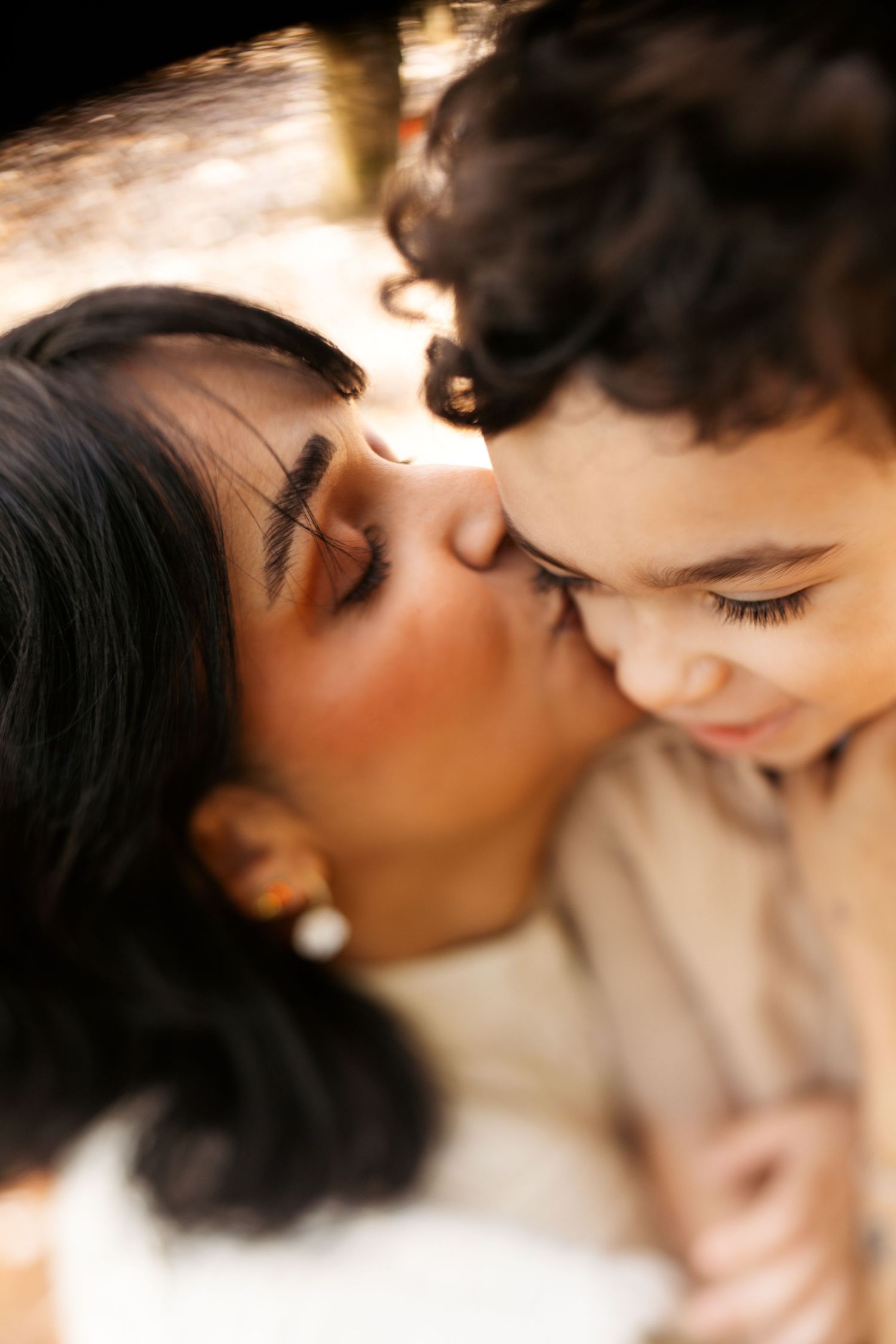 An intimate close-up moment captured in warm lighting with soft focus and natural expressions.