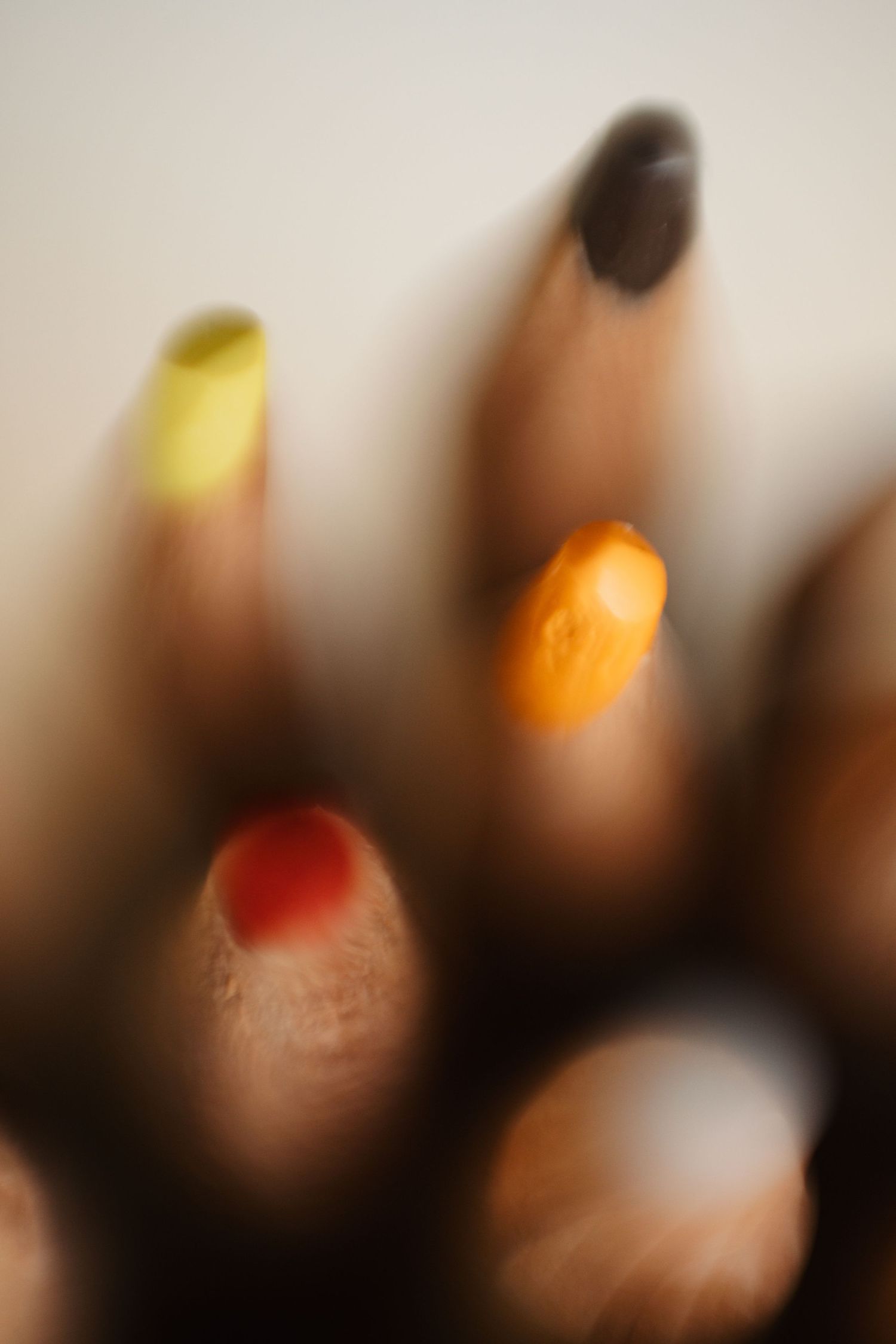 Blurred artistic photo sequence showing colorful light orbs creating an abstract pattern against dark background.