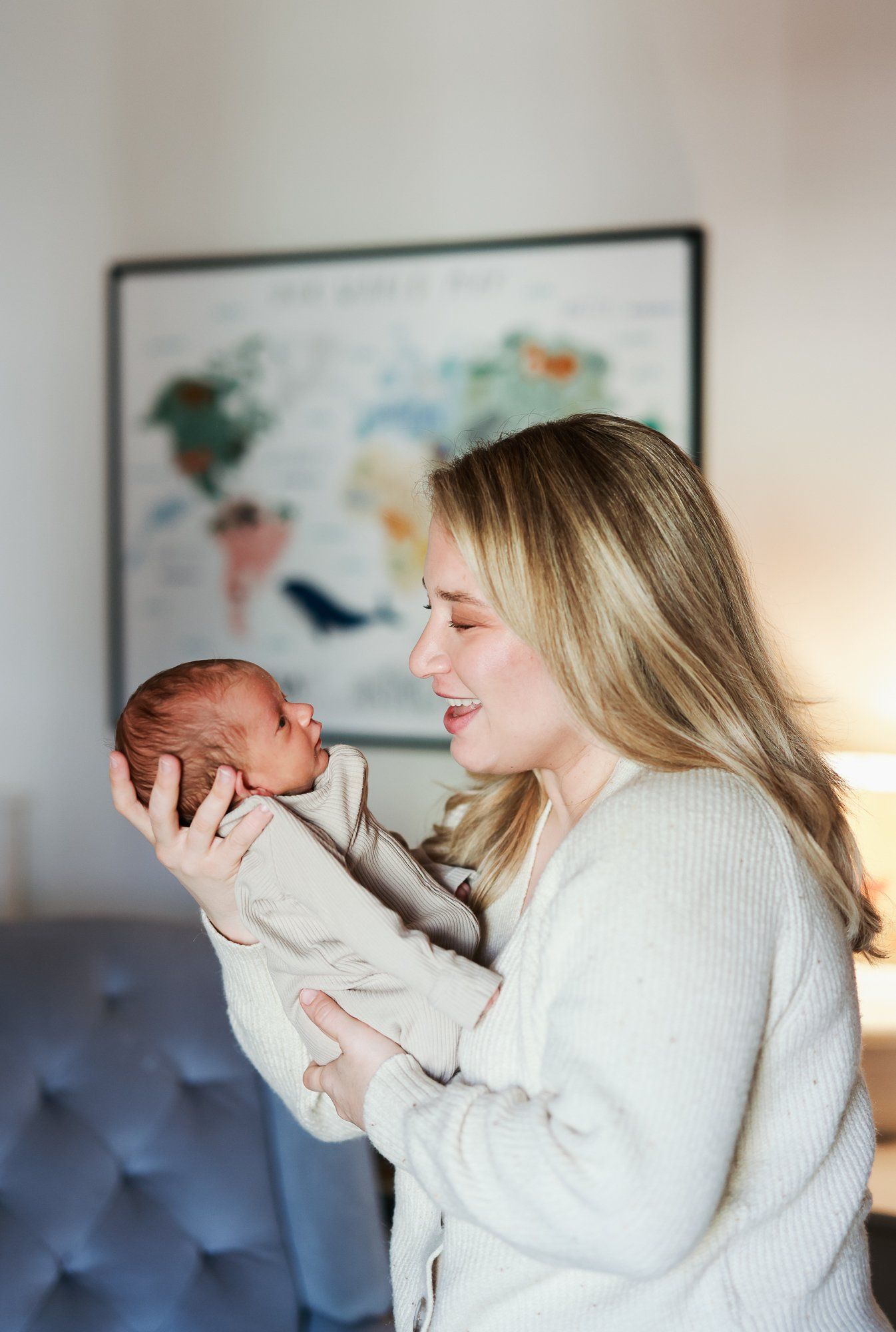 Four sequential photos show tender moments between parent and infant in a bright room with decorative wall art.