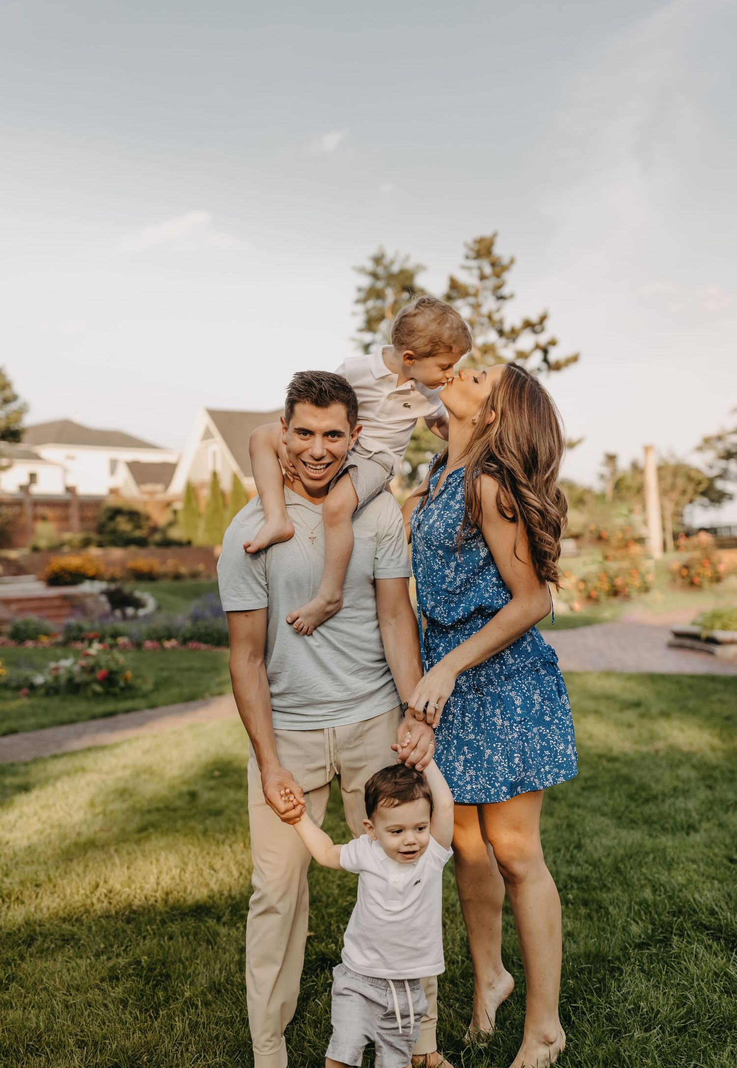 Family having fun and laughing together in a backyard garden setting.