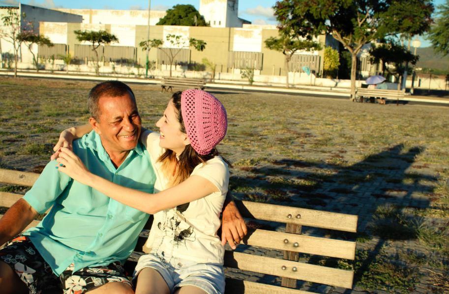 Romantic beachside photo sequence with couple on wooden pallets at golden hour.