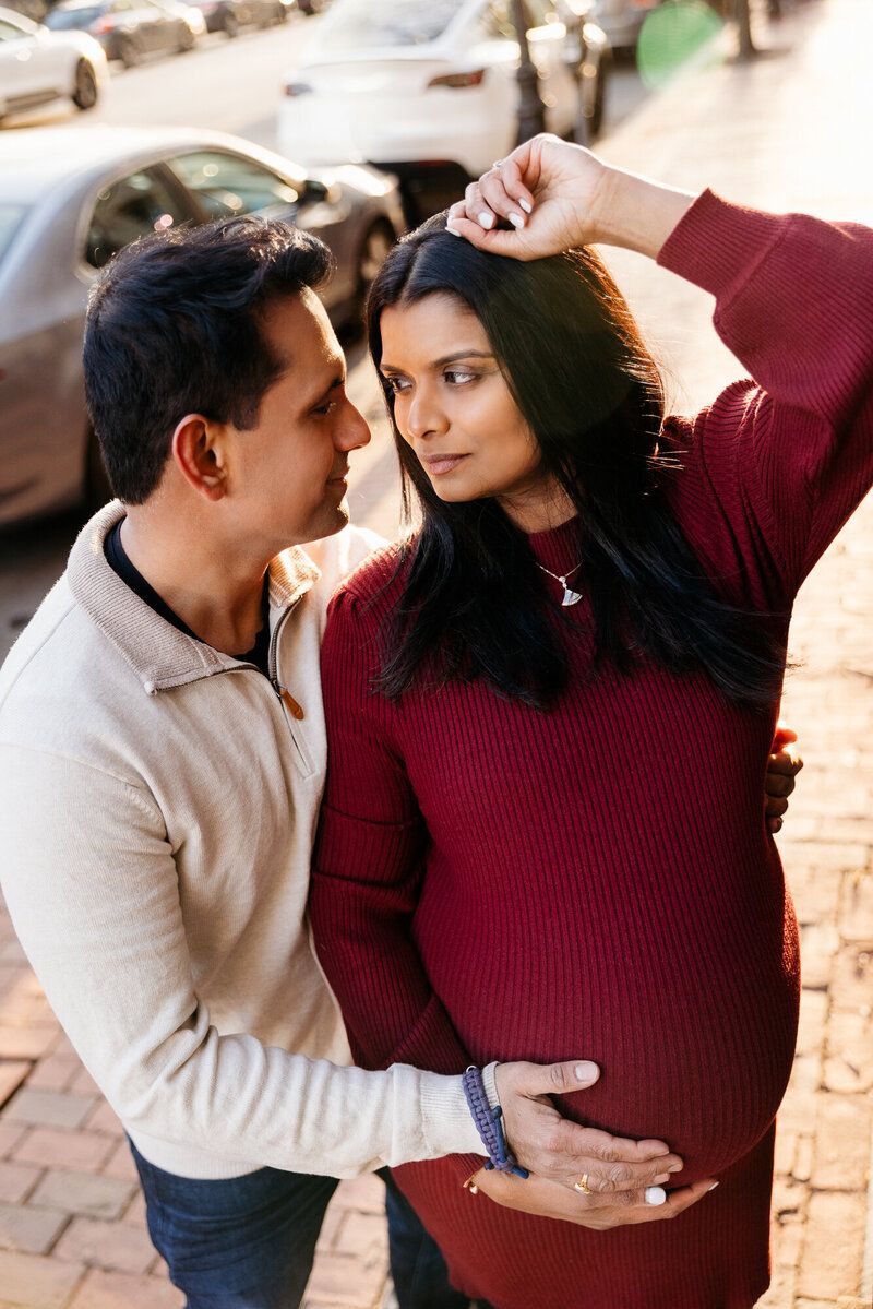Intimate couple portraits showing tender moments against a brick wall background.