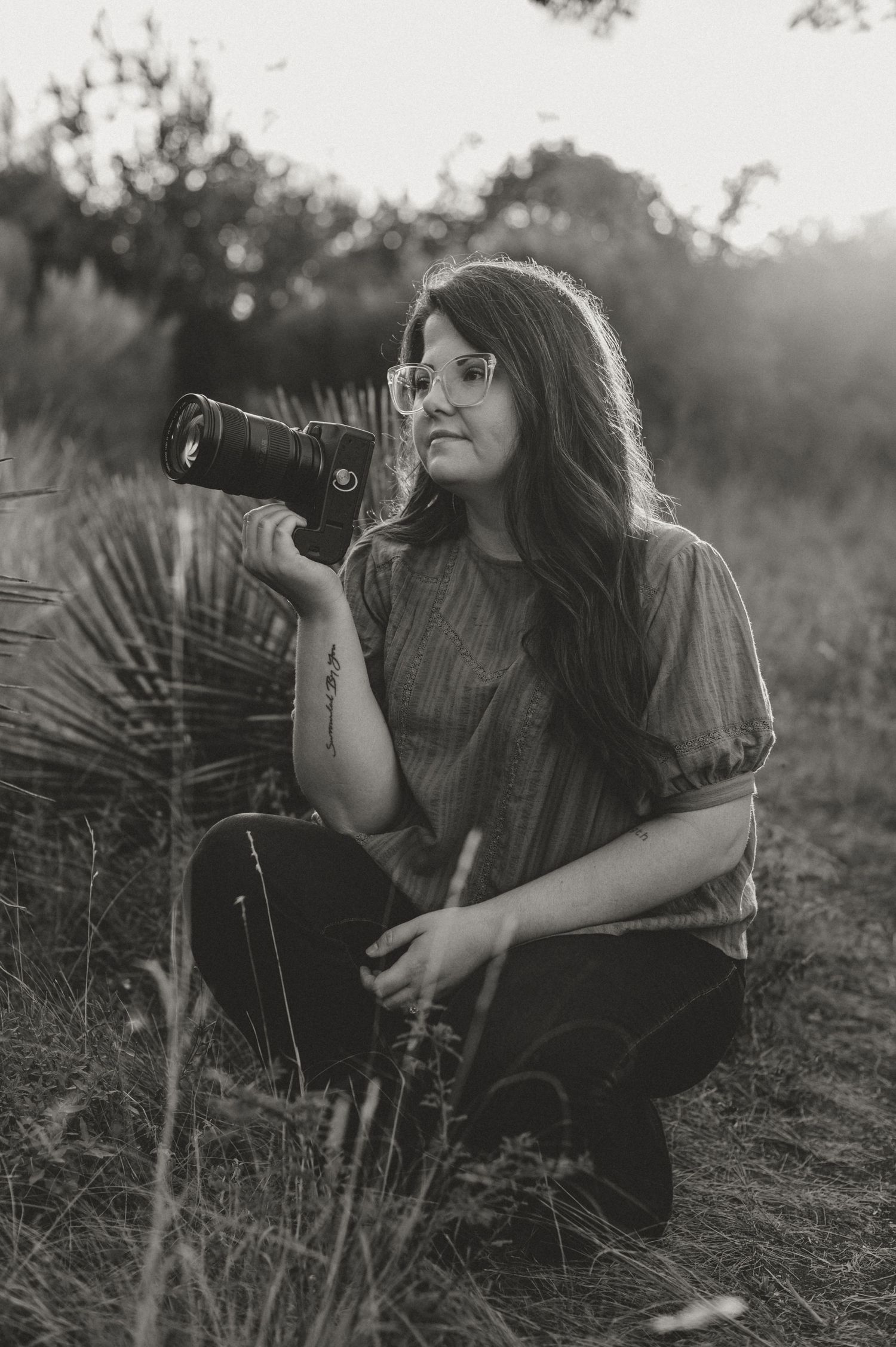 Kori Frazier Photography in San Antonio with her camera at Phil Hardberger looking off into distance