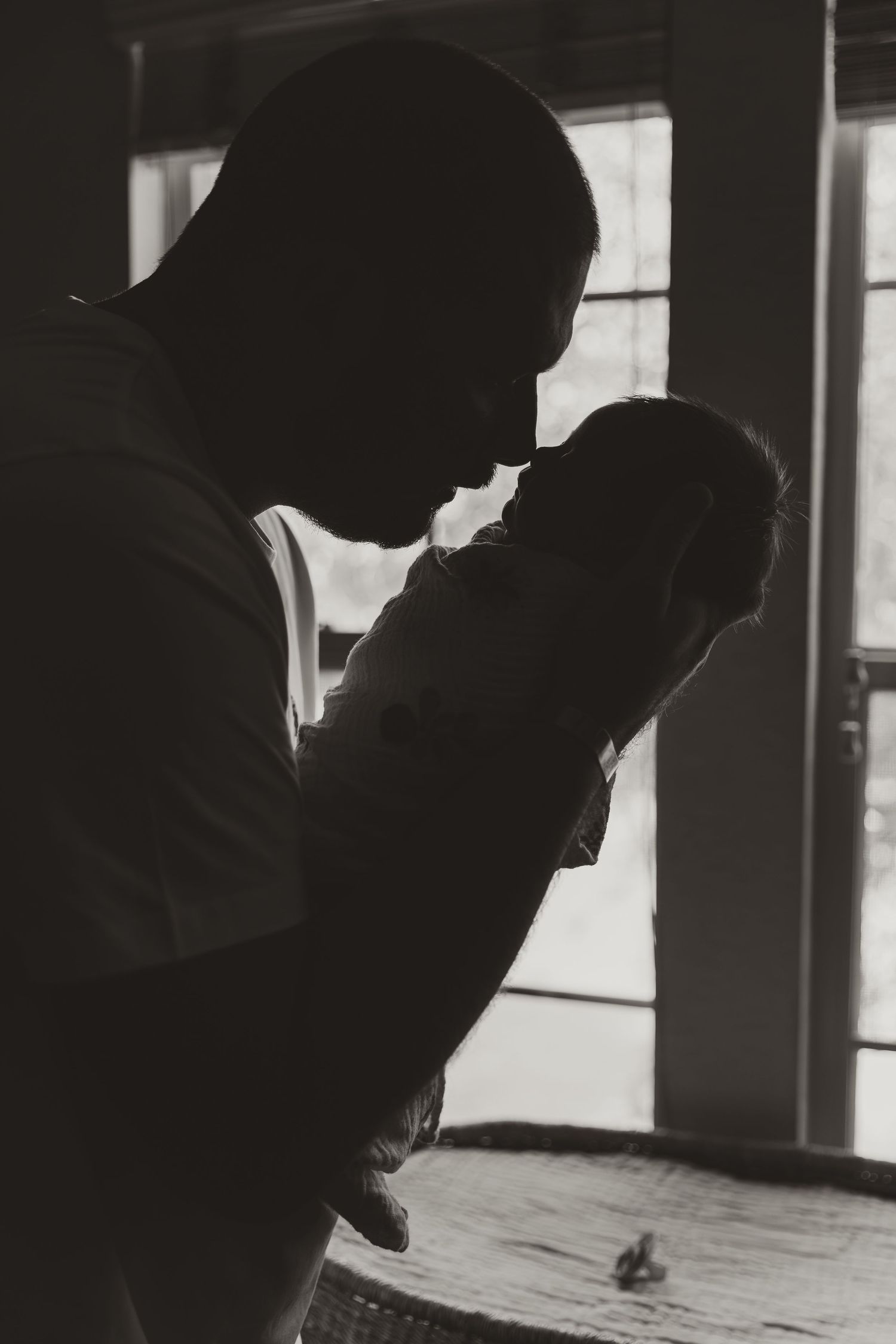 A series of black and white silhouettes showing a figure in a dark profile against a bright window background.