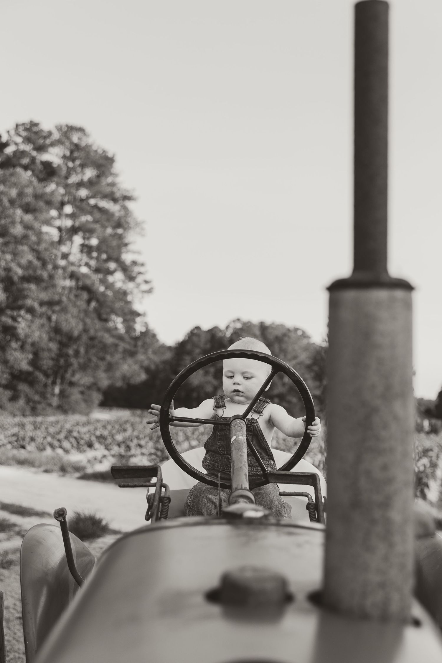 Black and white photo sequence showing a person sitting in a vintage tractor from different angles.