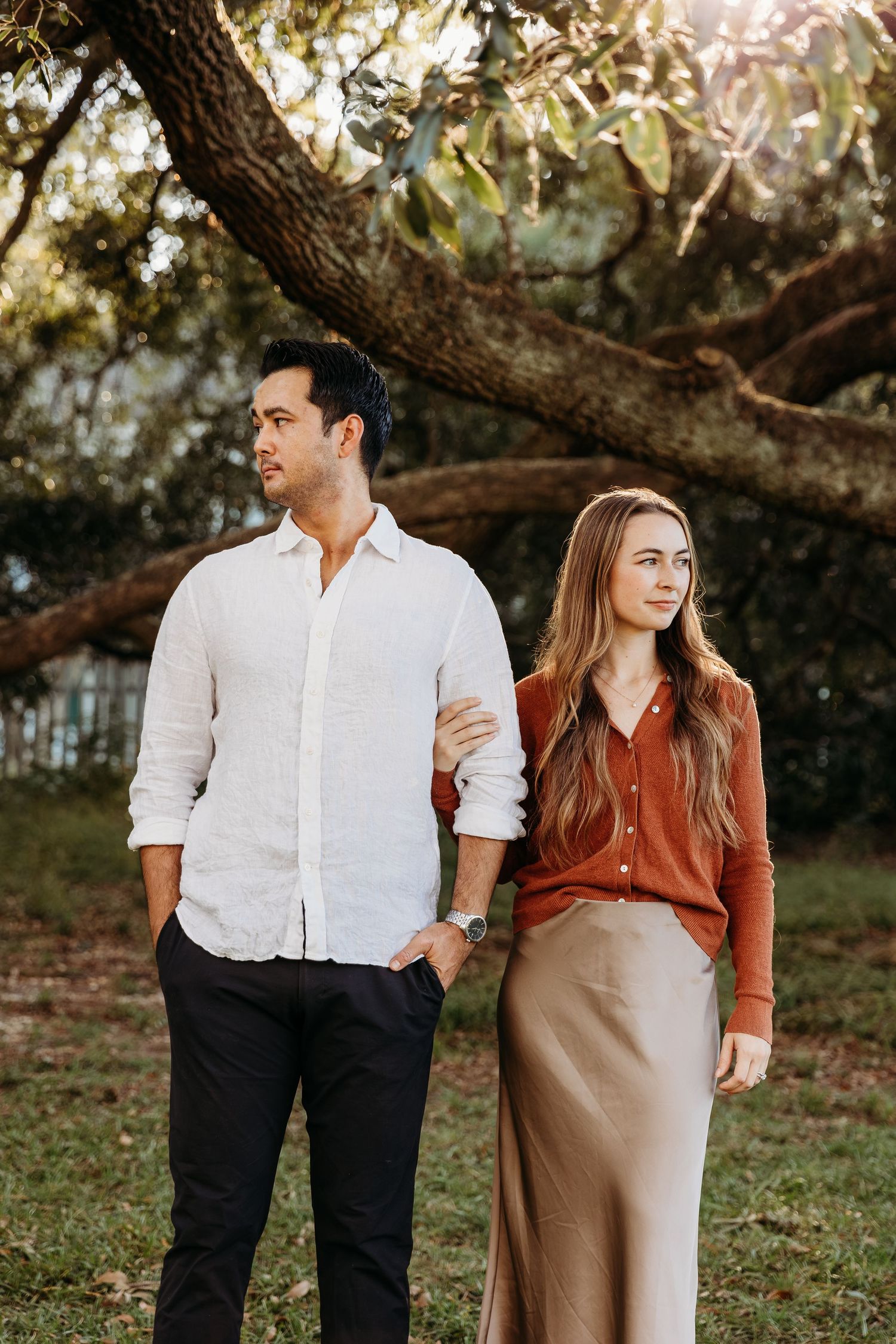 North Carolina Couples photo. holding his arm and looking in different directions