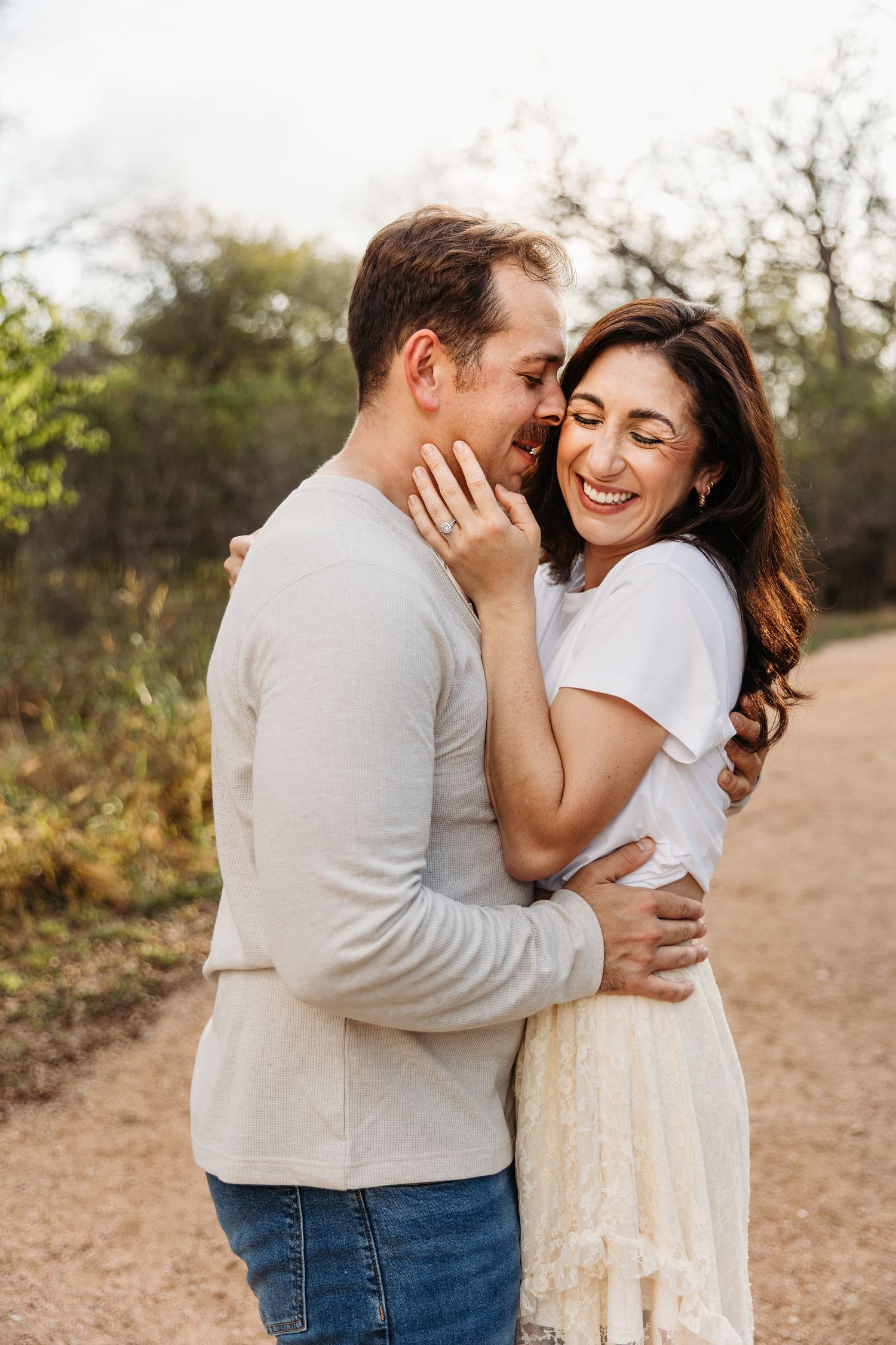 San Antonio couple snuggling at crescent bend nature park.