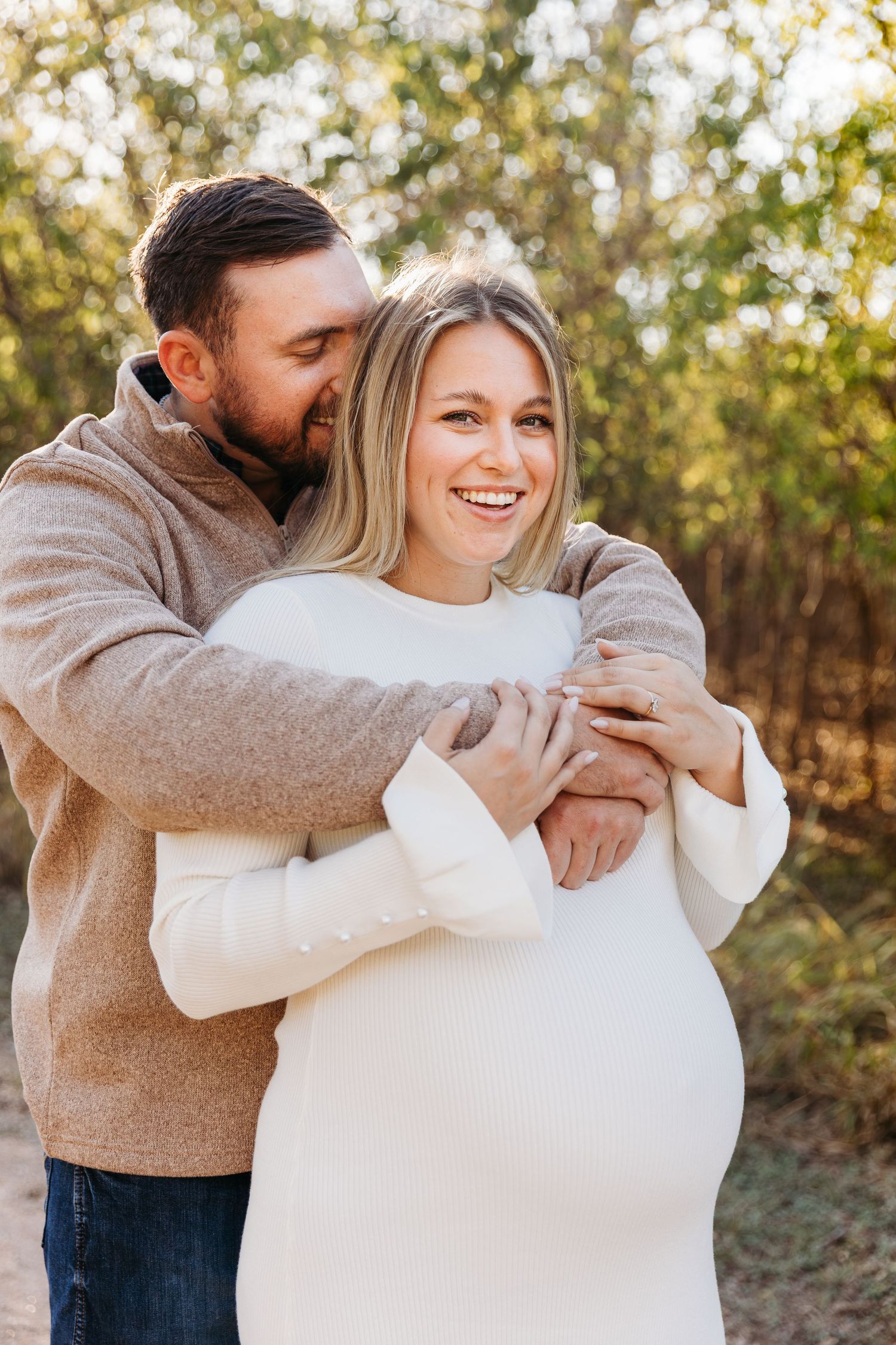 San Antonio couple snuggling at crescent bend nature park.
