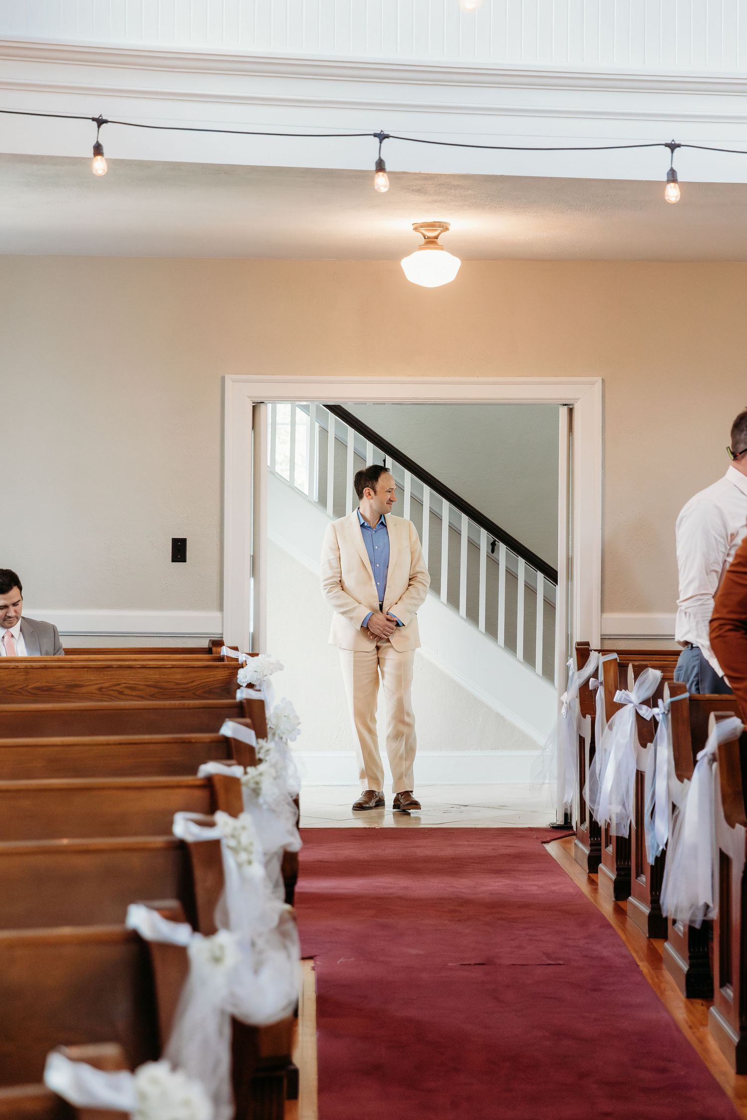 A sequence of wedding ceremony preparations showing white tulle decorations being installed along church pews.