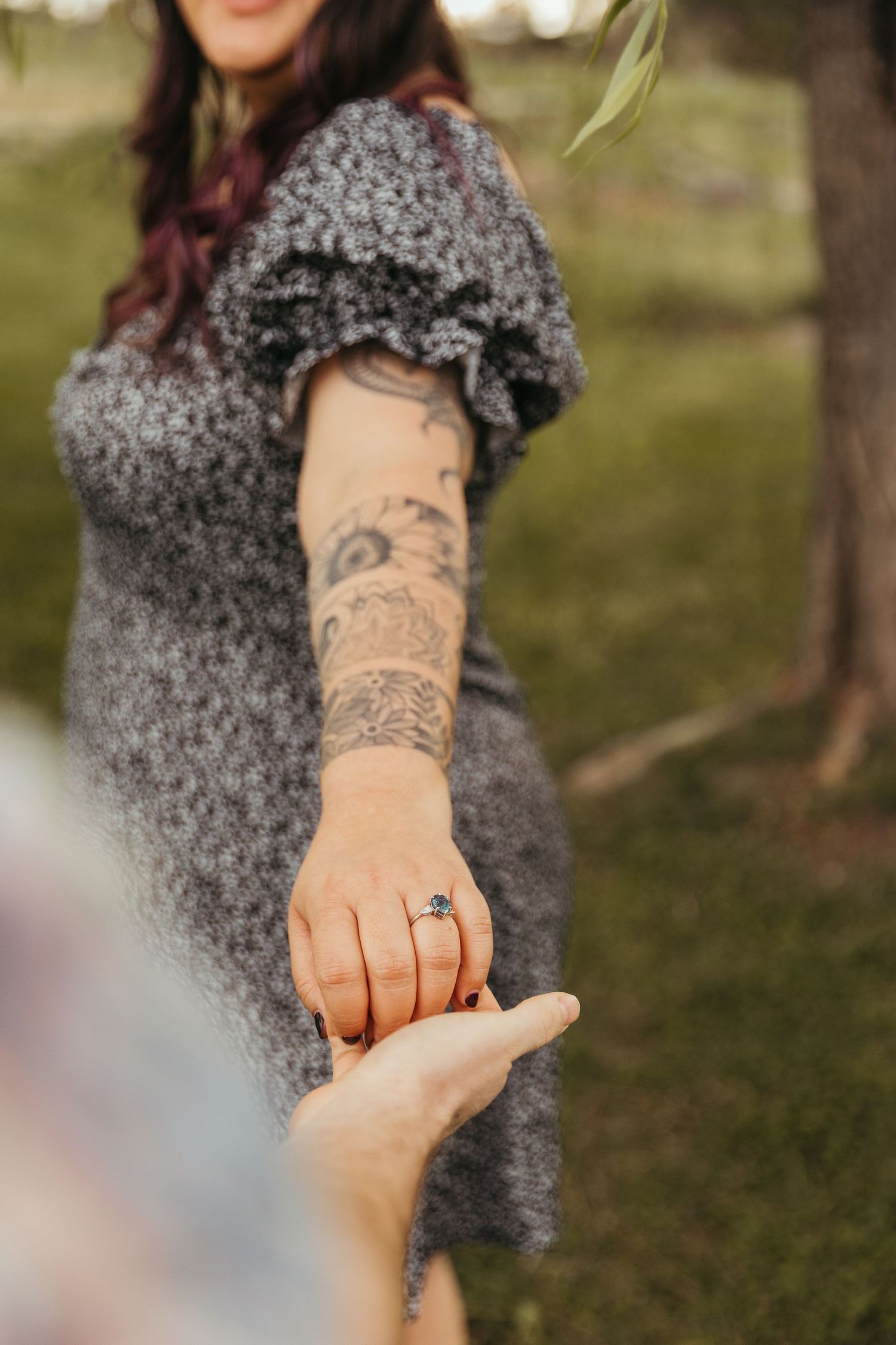 A series of photos showing a tattooed arm reaching out to hold hands in a romantic gesture outdoors.