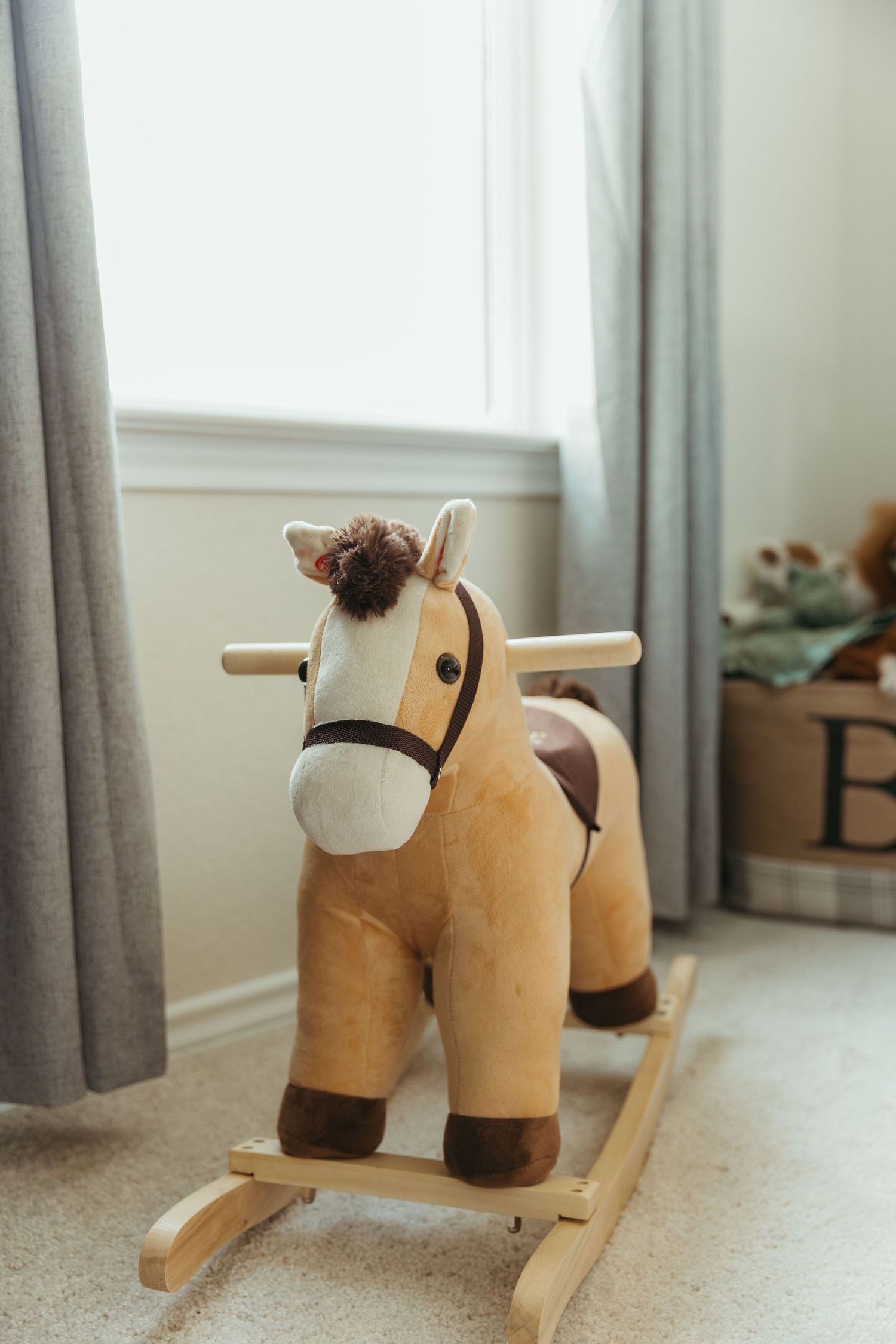 A wooden rocking horse toy photographed from multiple angles on a carpeted floor with gray curtains in the background.