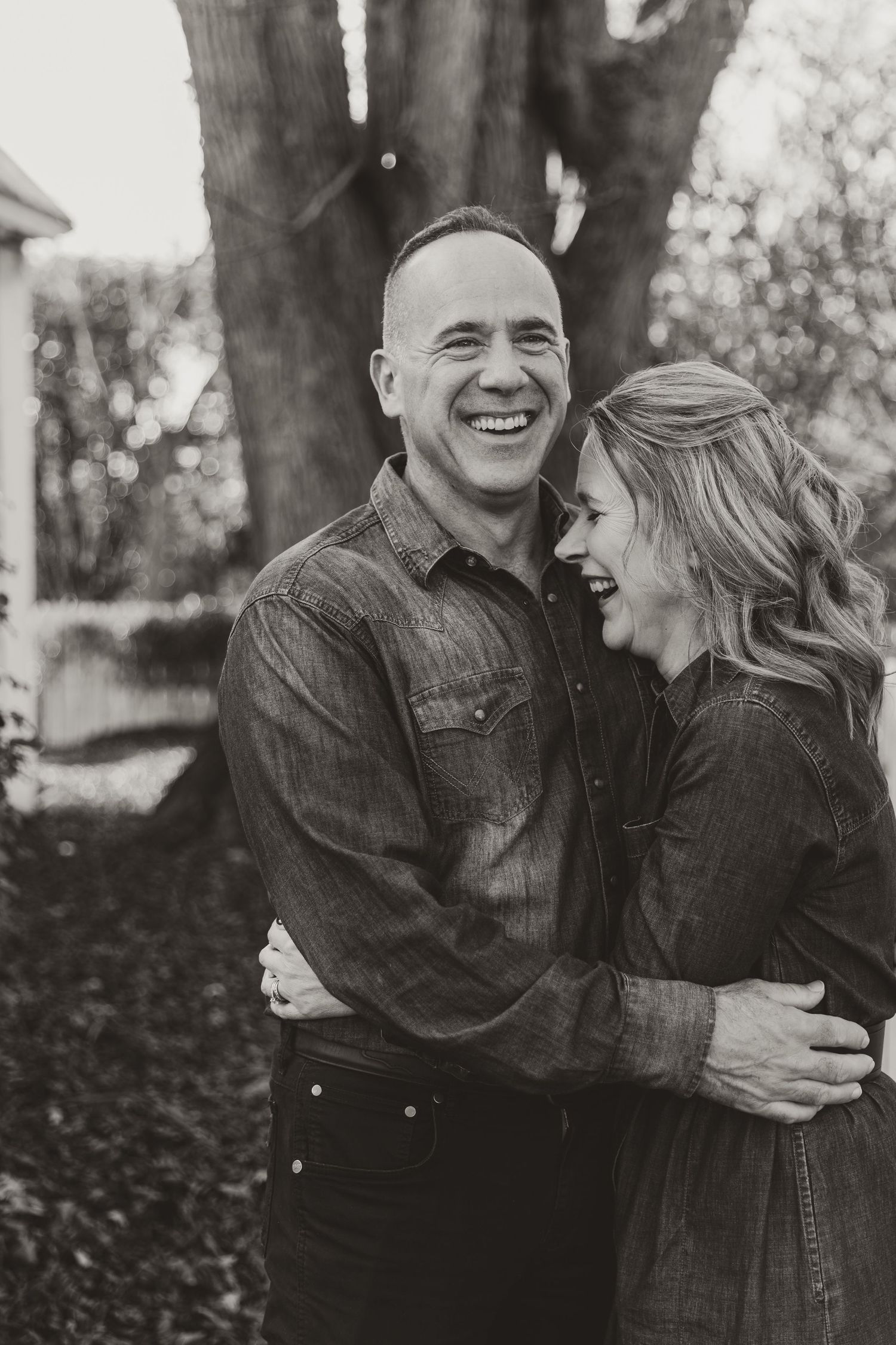 older couple smiling and laughing while hugging