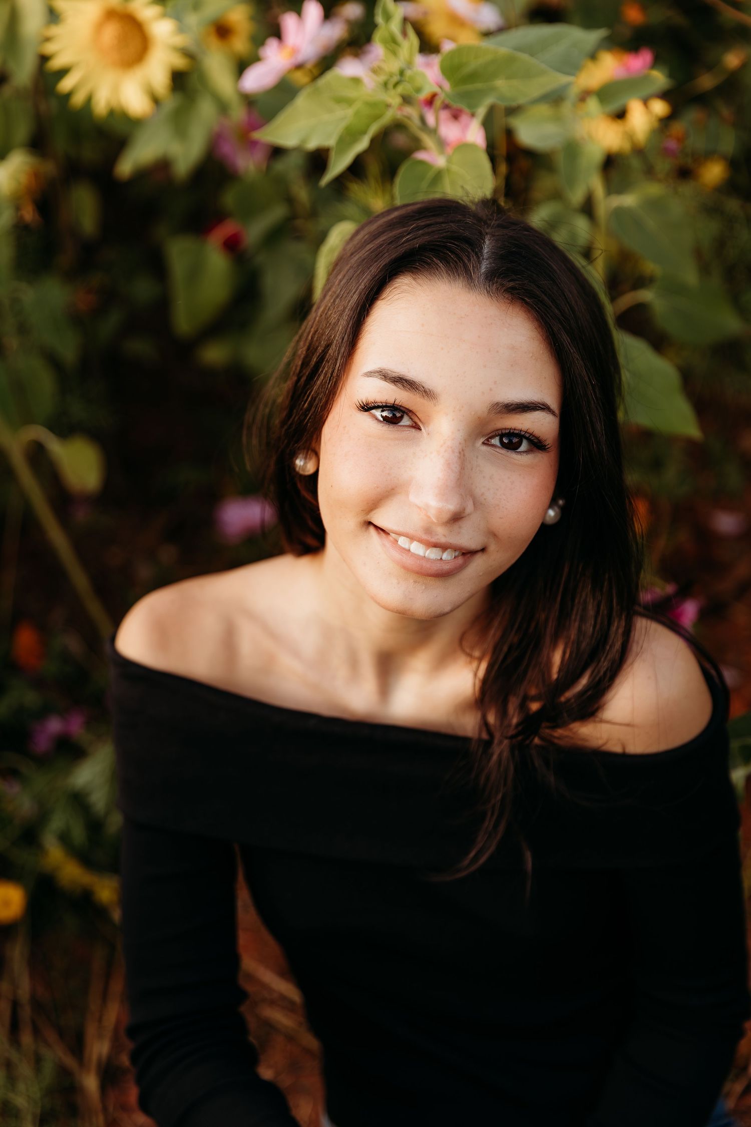 A series of outdoor portrait photos with sunflowers and pink flowers creating a natural garden backdrop.