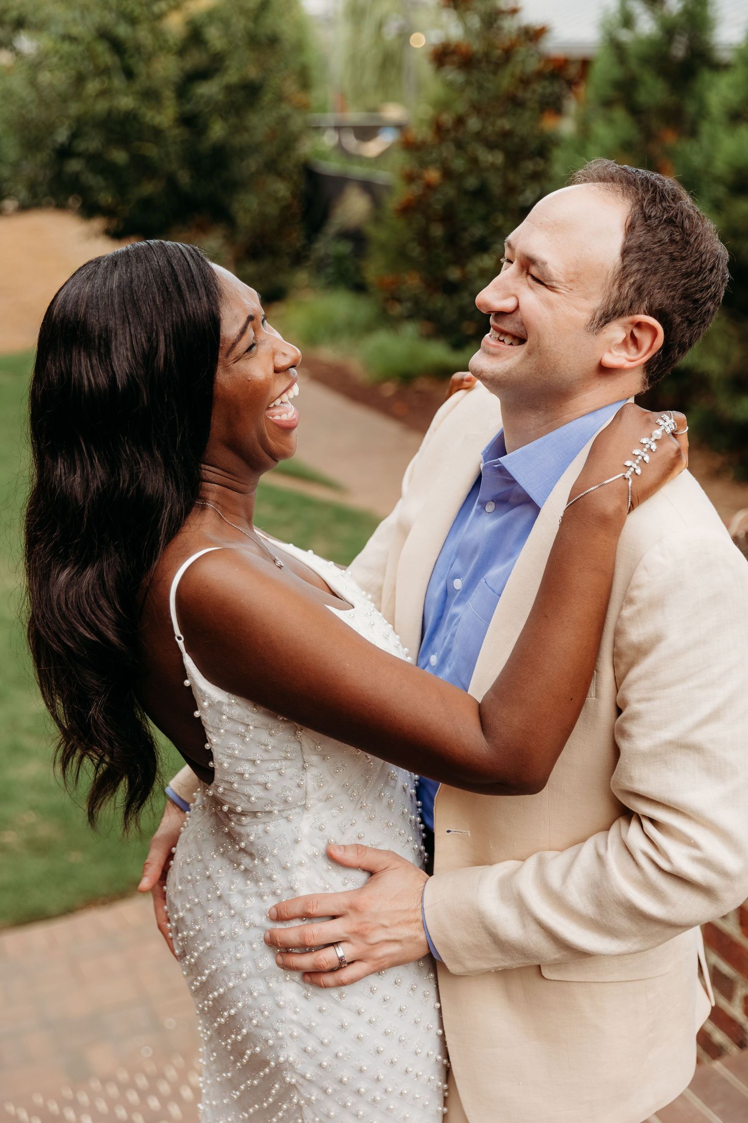 A romantic sequence of candid moments between newlyweds dancing and laughing together outdoors.