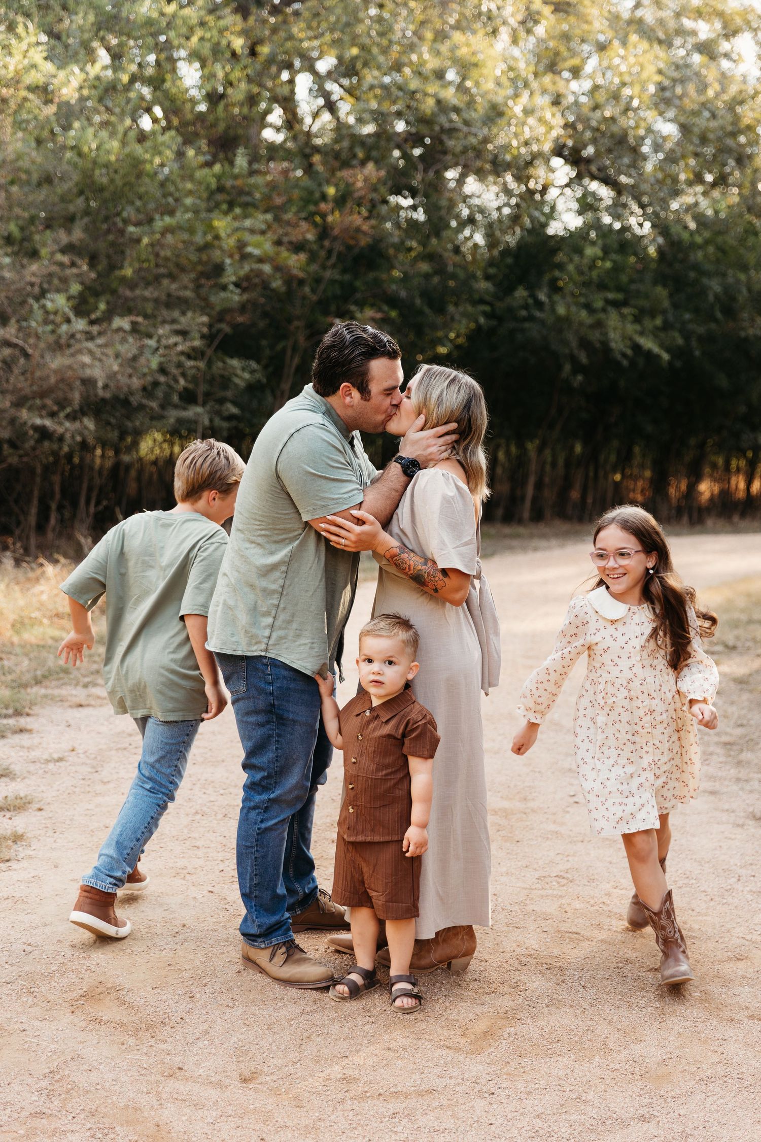 San Antonio family snuggling at crescent bend nature park. Kids running circles around parents